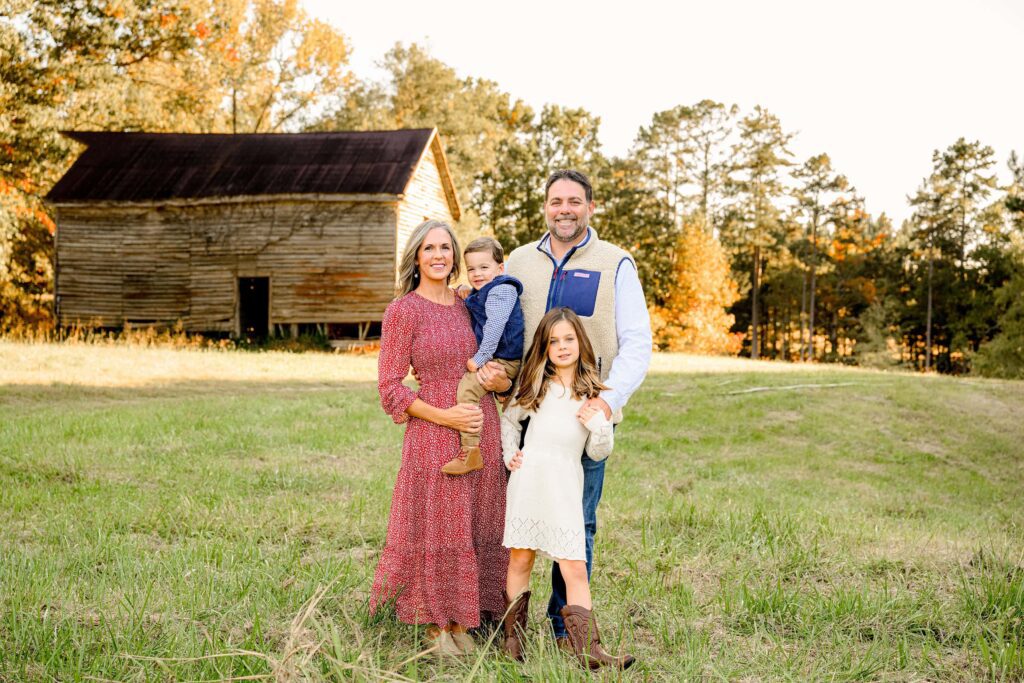 Charlotte NC area family of 4 dressed in all the fall colors, posed together during a fall family mini session in Lancaster, SC