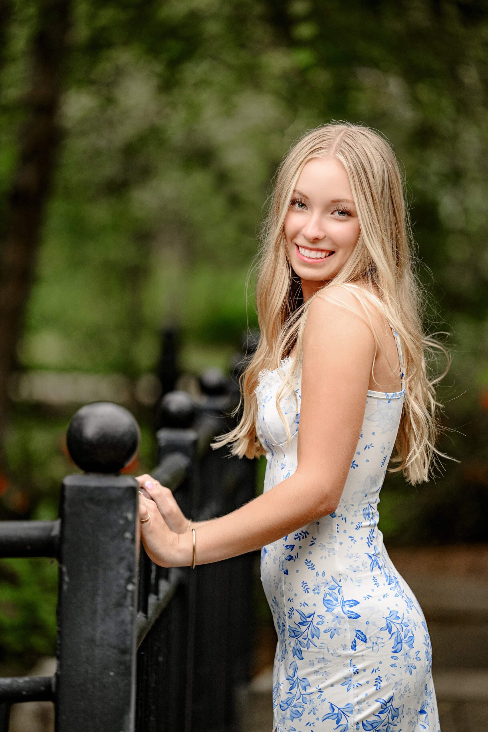 blonde charlotte grad in a rock hill sc wearing a floral dress with her hair down