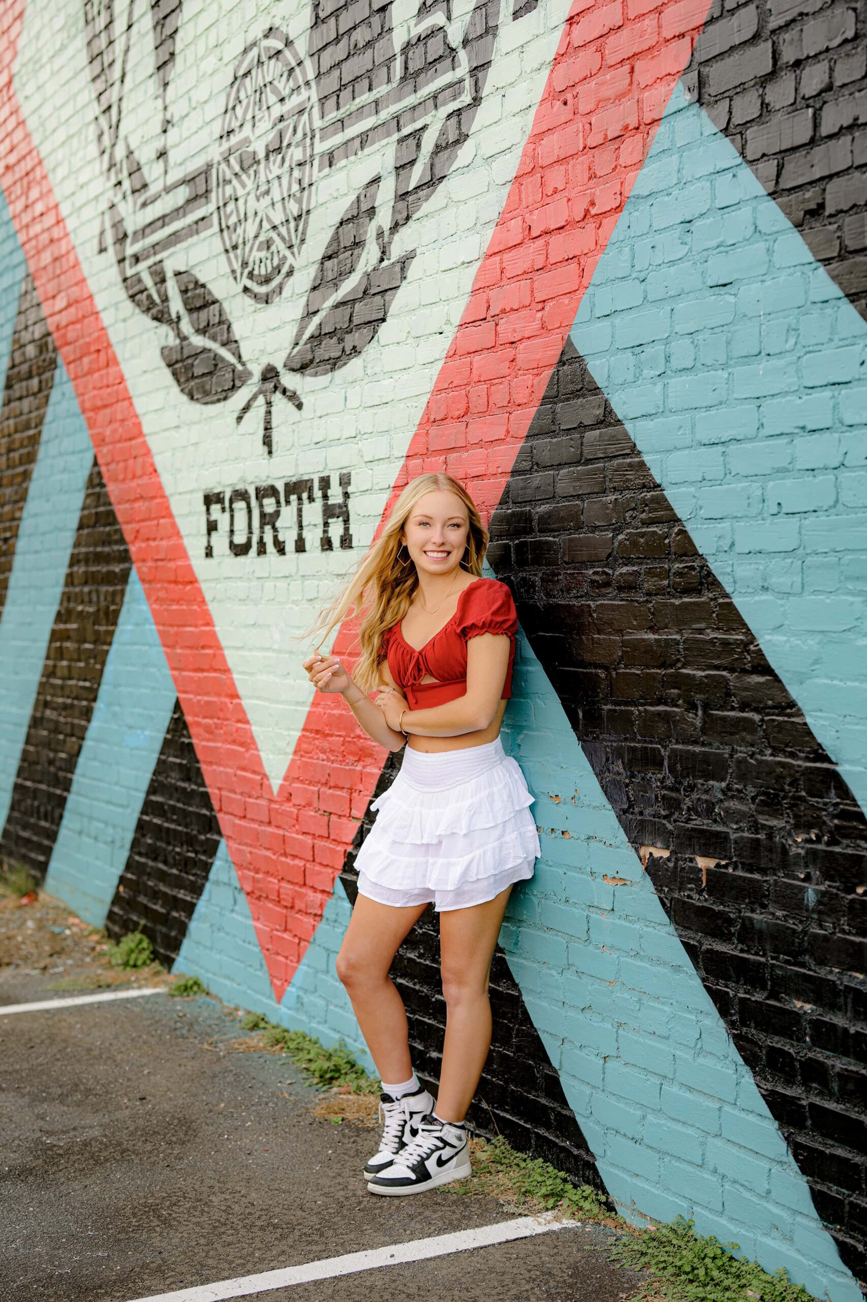 urban look for charlotte senior leaning against a wall in rock hill sc