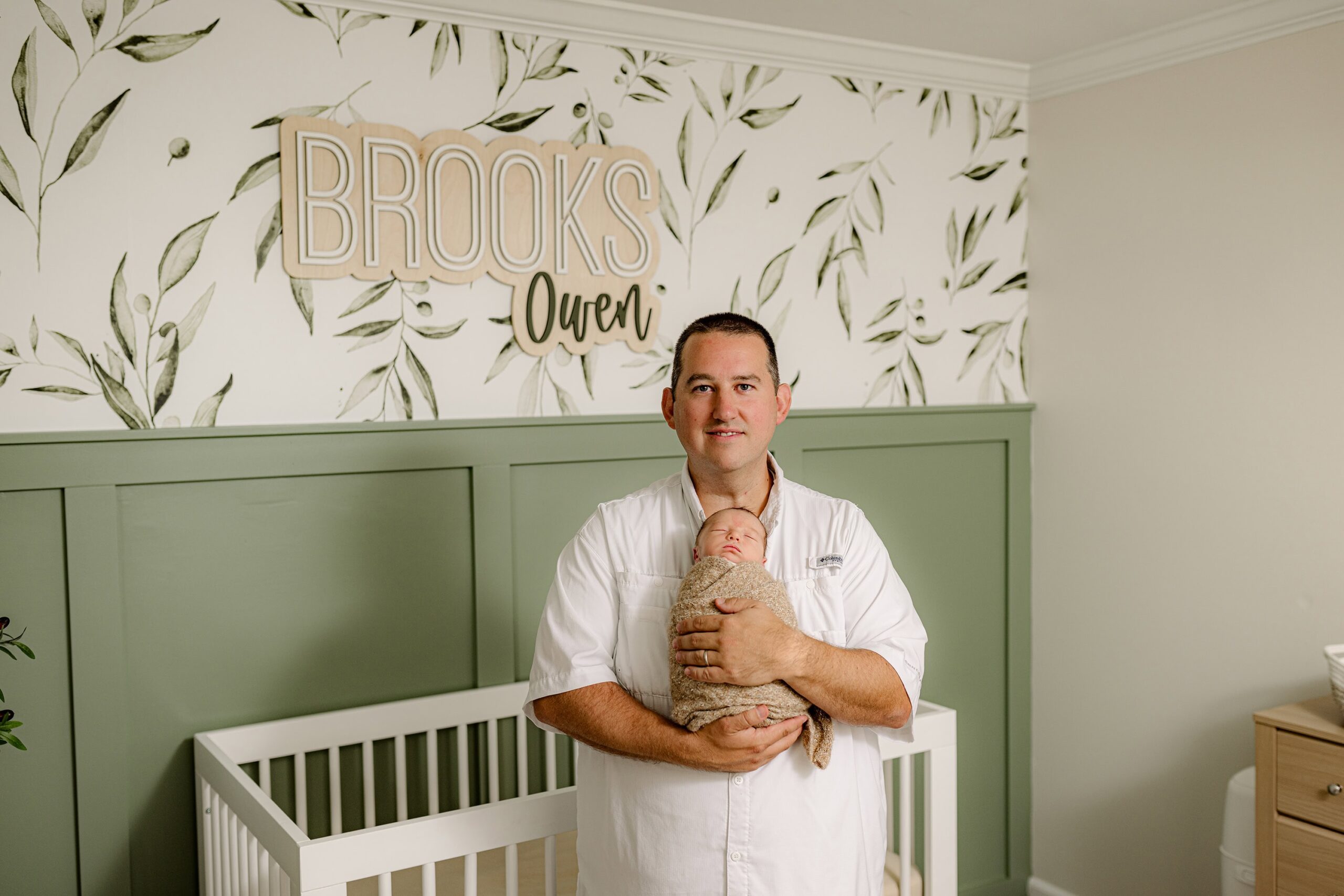 dad holds son in their indian land sc home during their newborn session