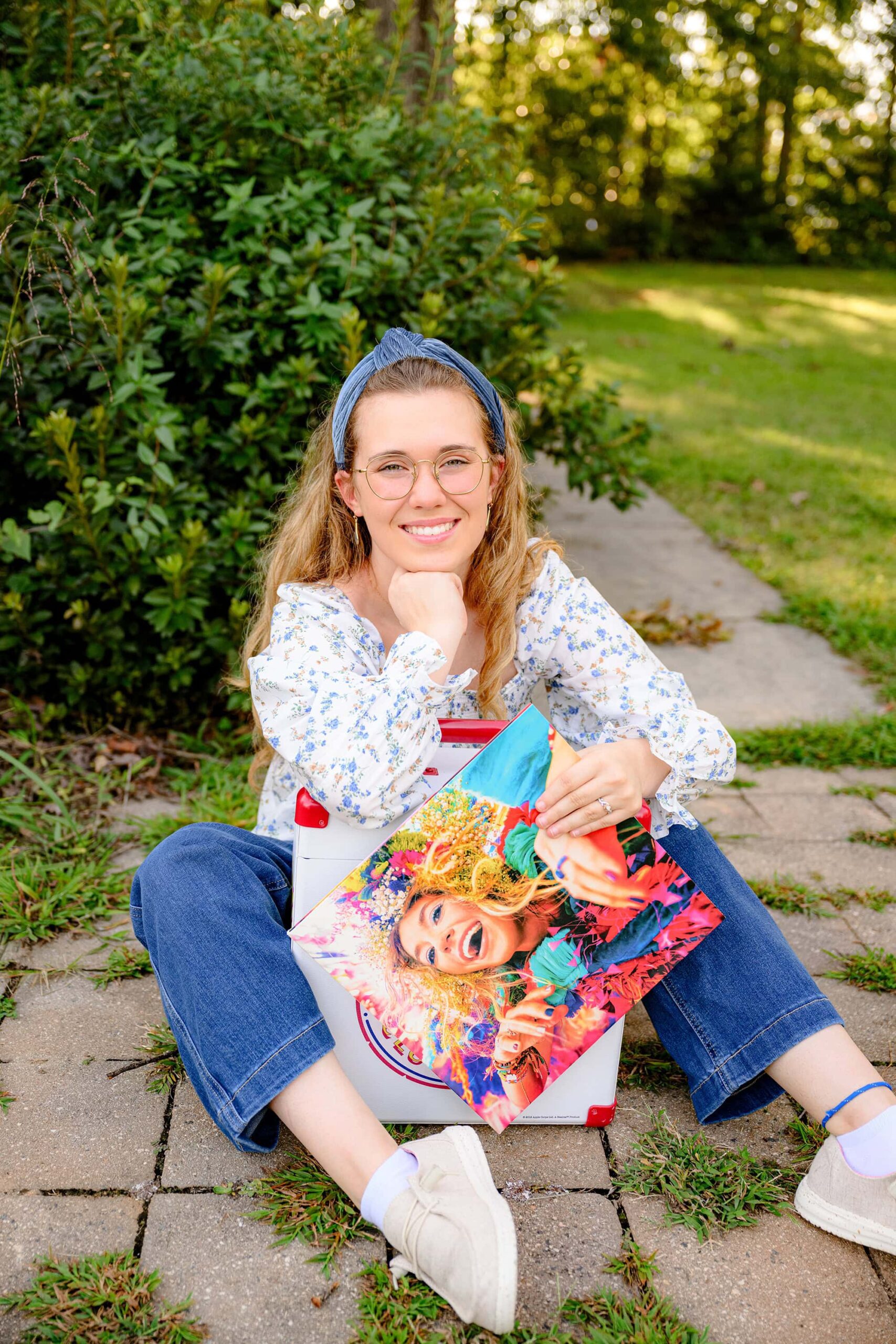 creative senior photo of a grad girl holding her favorite record as part of her senior portrait session