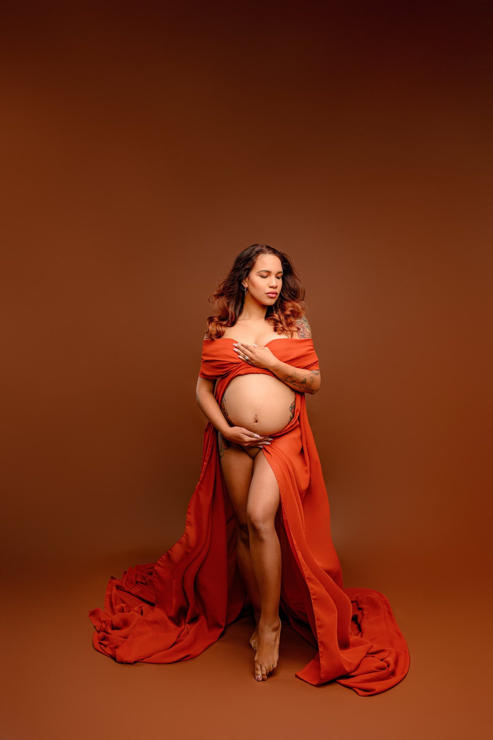 Captured in my Waxhaw studio, this elegant maternity shot features the mama in the same Grecian-inspired pose, but now looking down and to the left. Her expression and the flowing chiffon create a powerful, artistic moment.