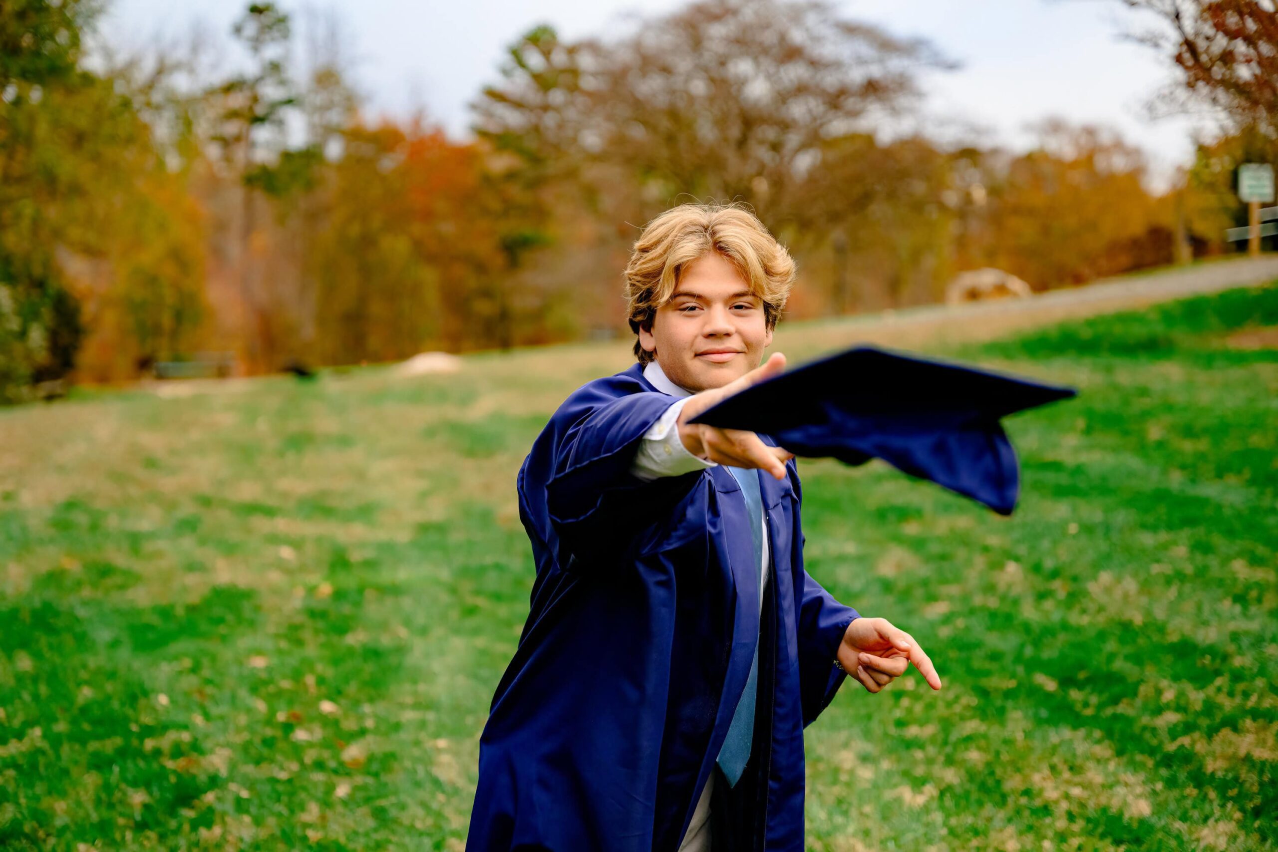 Waxhaw, NC Cuthbertson High School grad tosses his cap during his senior portrait session