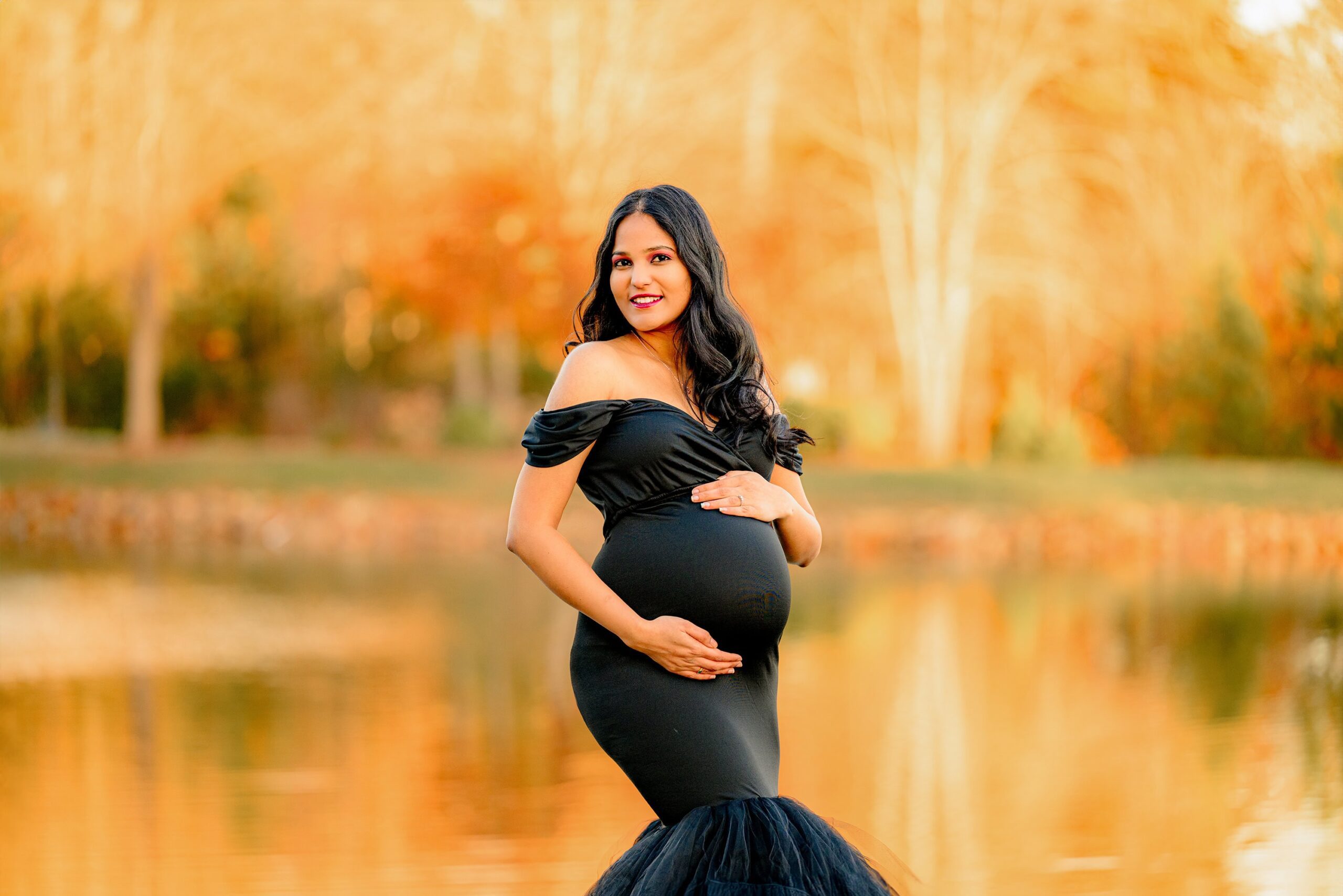 golden glow behind this charlotte area mother as she poses in black