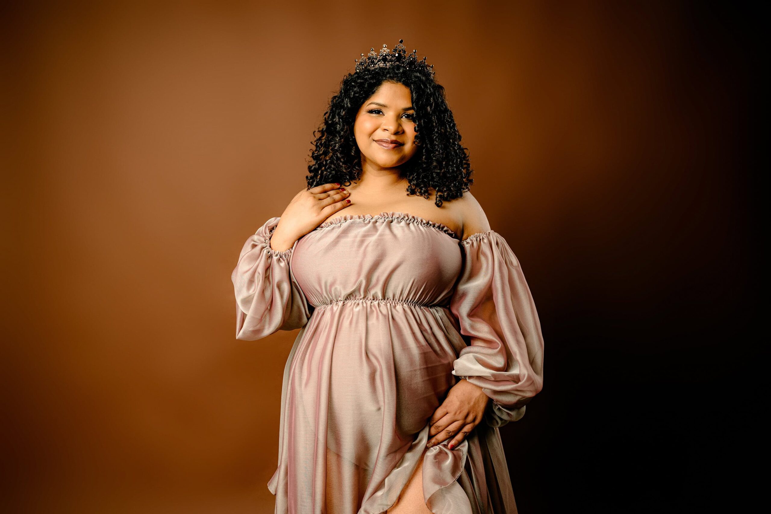 waxhaw studio maternity session with a dark curly hair mom in a brown dress and on a brown paper