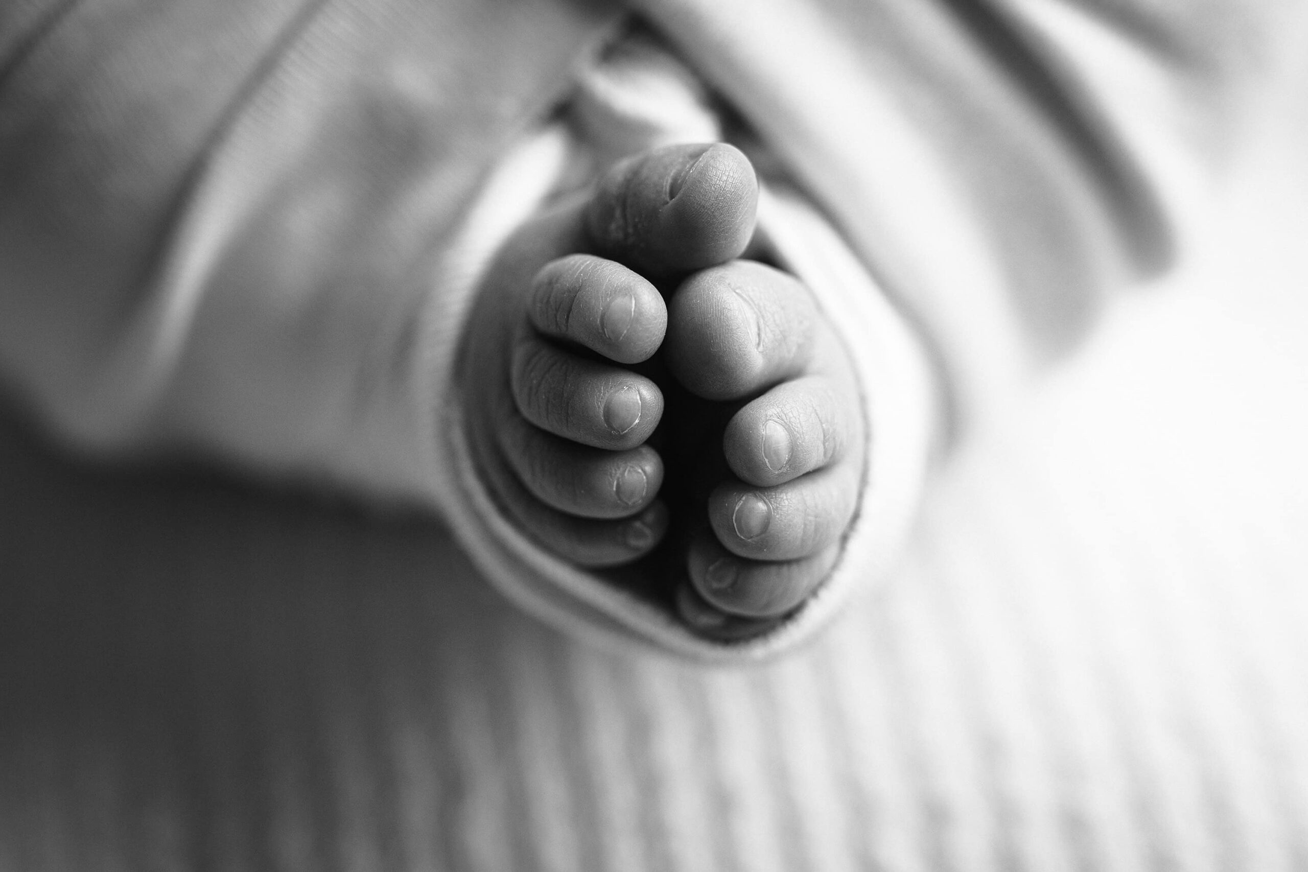 black and white baby girl isla detail photos of top down photo of her feet together