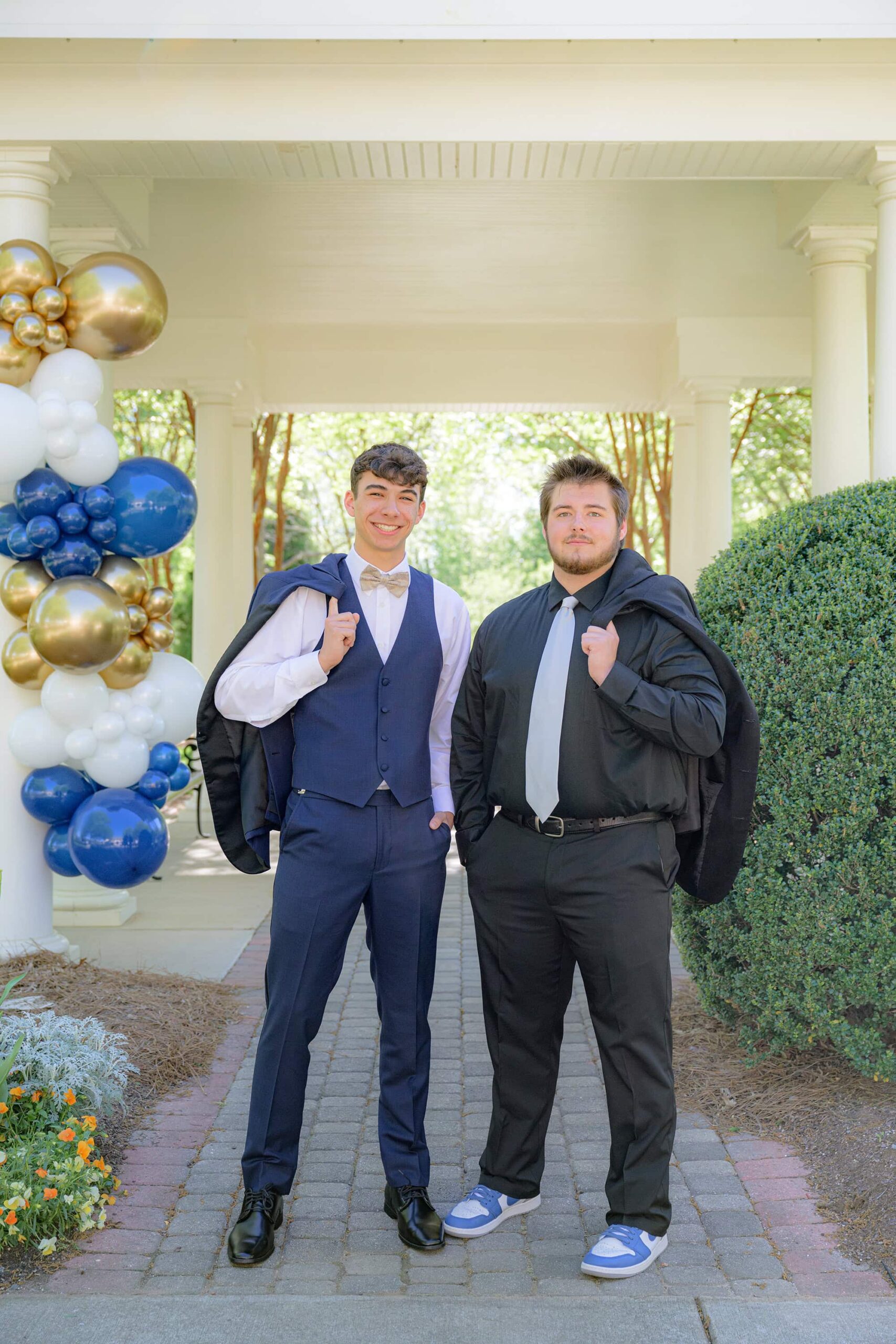 two boys in grey and back suits for senior prom