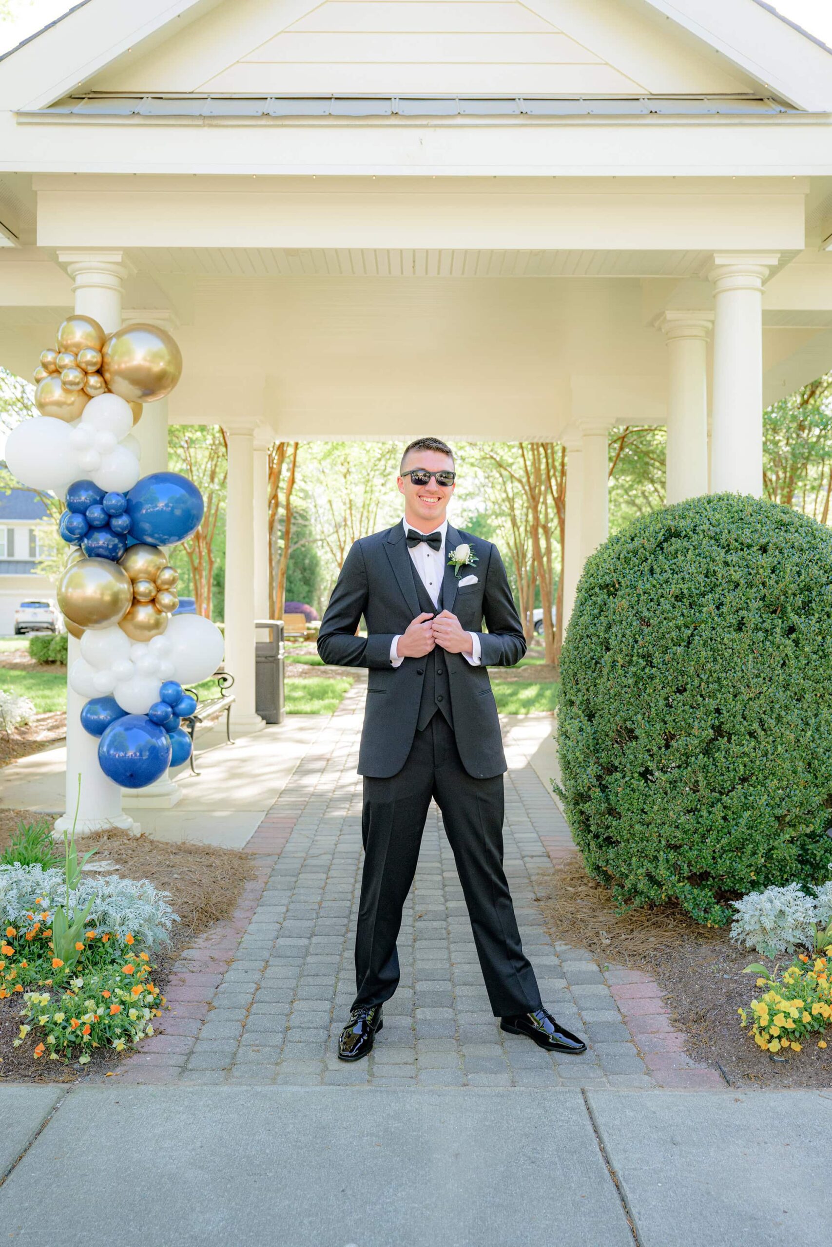guy wear formal black tux and sunglasses for senior prom photo