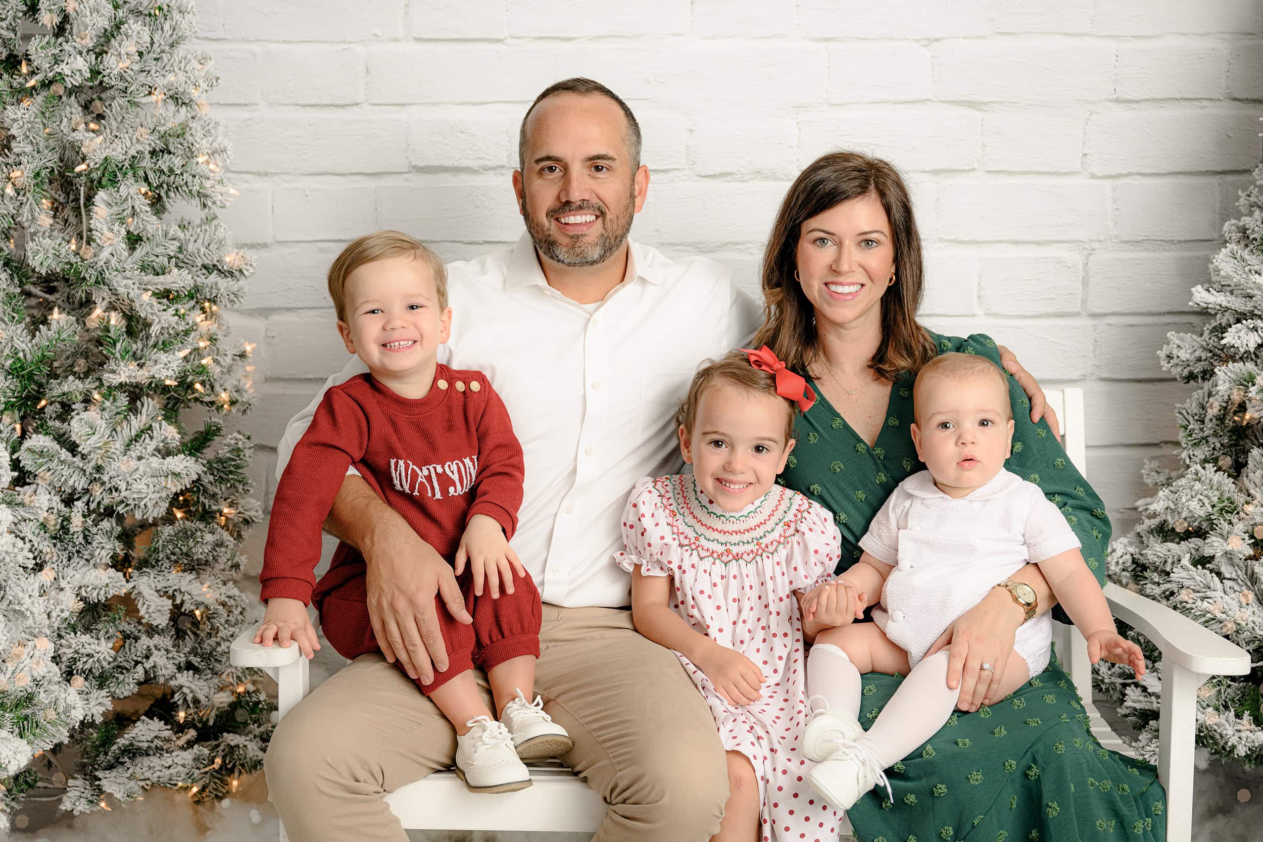 Charlotte NC family of 5 sitting during their holiday white christmas mini session dressed in holiday colors