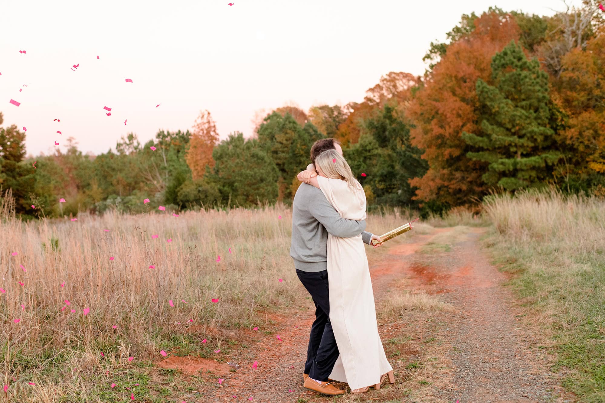 couple hugs after the gender reveal "its a girl"