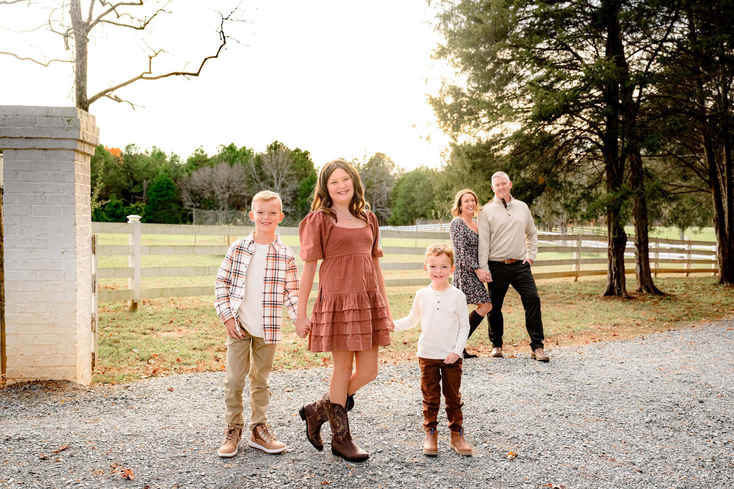 family of five during their charlotte family photography session in the fall in a downtown waxhaw park