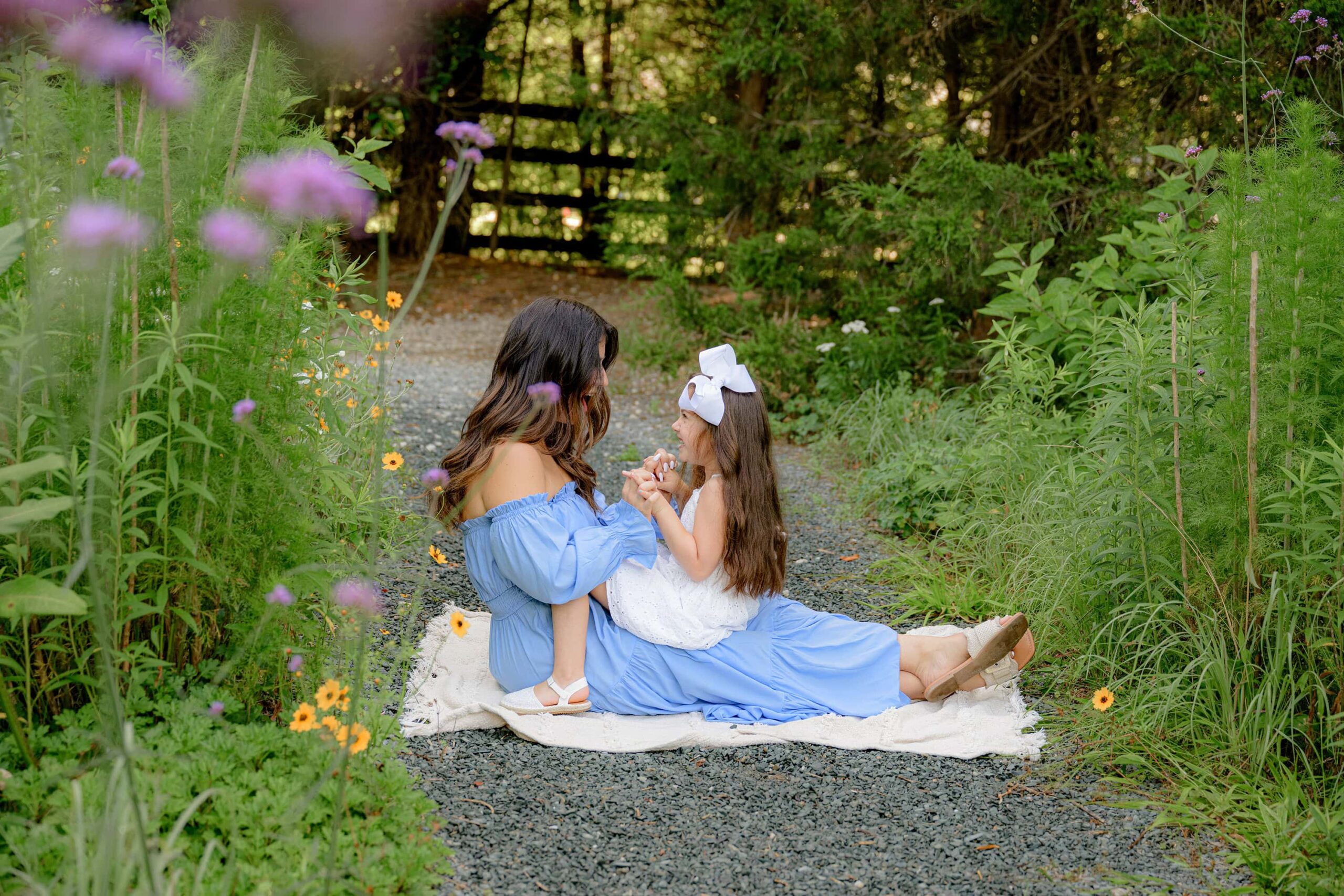 mother and daughter share a moment together  sitting in a waxhaw area park []