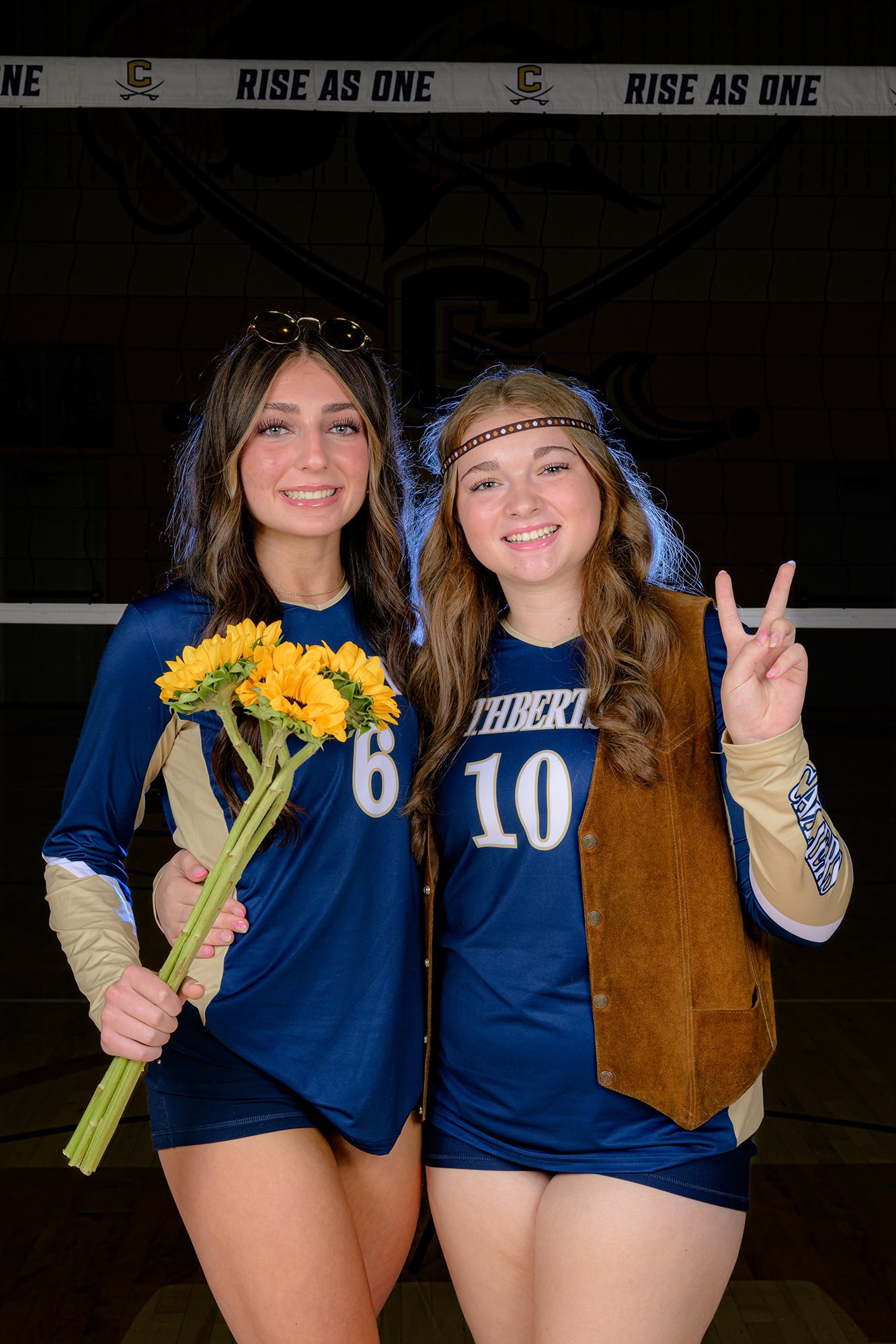 hippie spirit day with volleyball players wearing a leather vest, headband, and holding flowers
