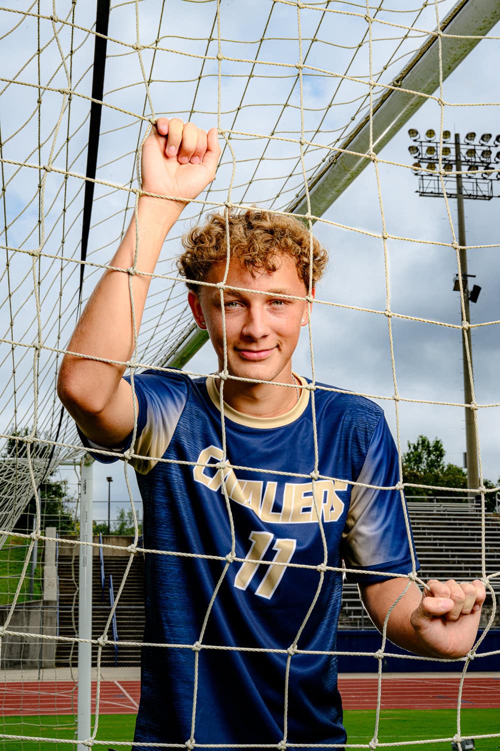Charlotte area senior in a soccer goal for his senior photos