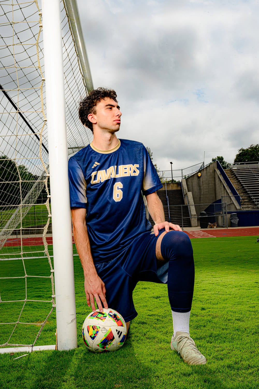 High school senior cuthbertson soccer player in his jersey kneeling
