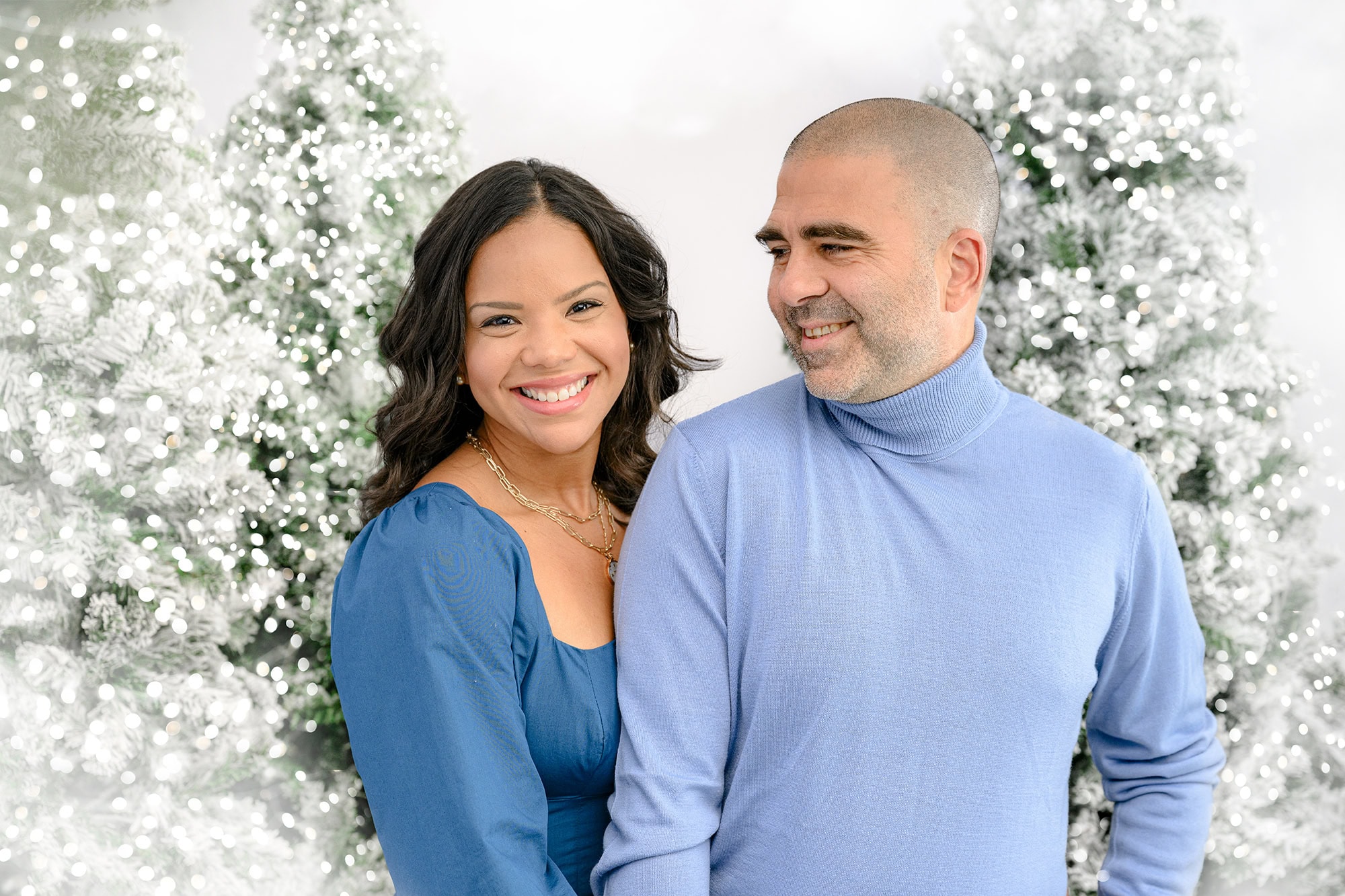 mother and father dressed in blue in a holiday set up