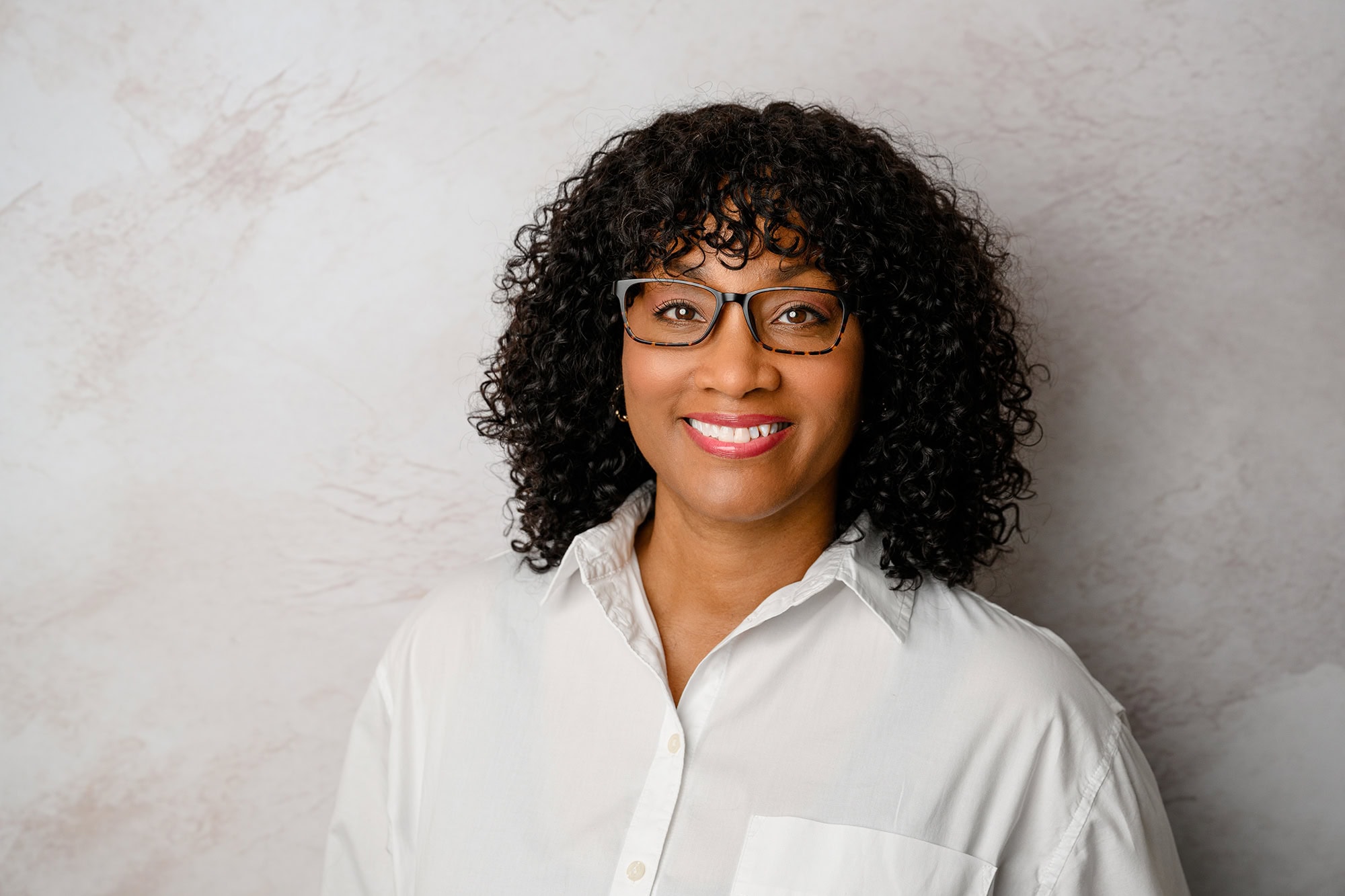 classically styled client on textured background for multiple uses in her studio headshots