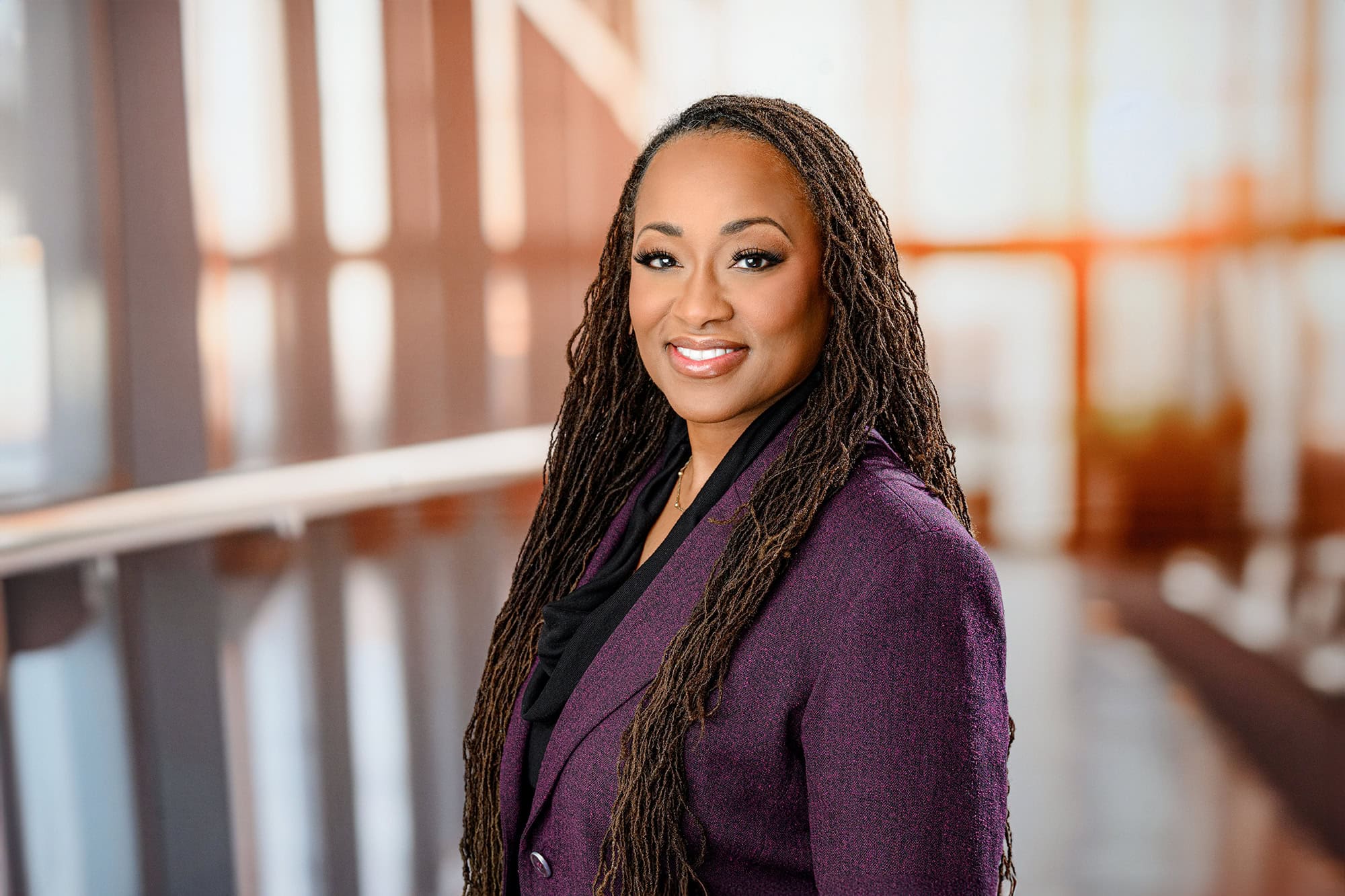 charlotte woman wearing purple jacket in corporate setting for headshot