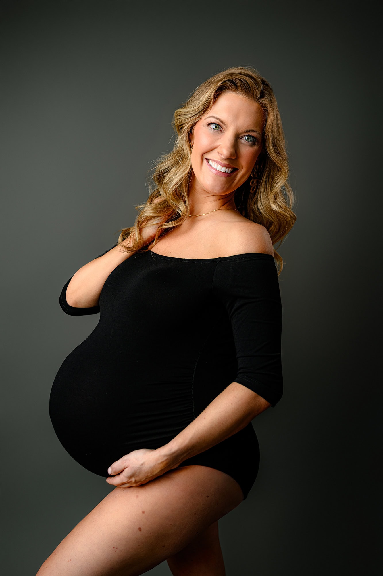 mom to be studio maternity photography session of mom wearing a black bodysuit