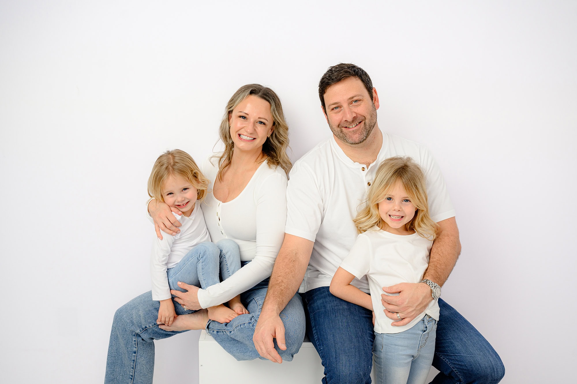 Family of four in a studio family photography session during the winter