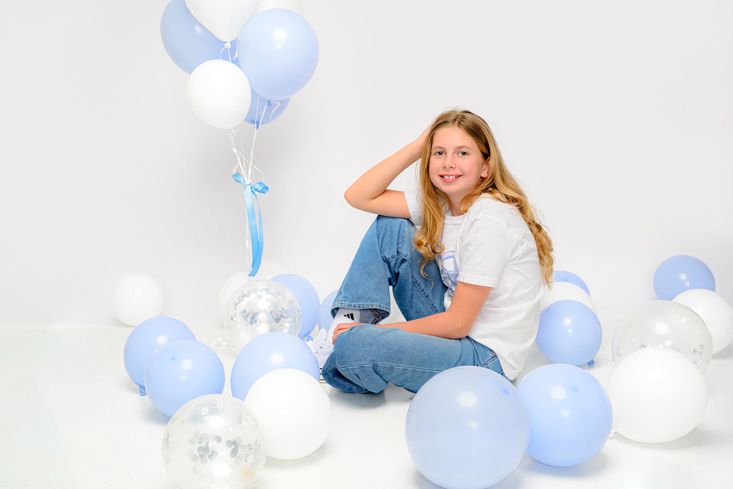 charlotte girl surrounded by balloons for her tenth birthday