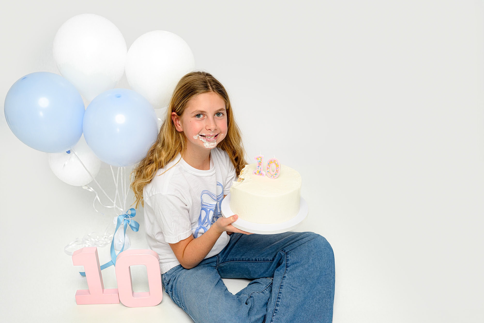 smiling 10 year old client holding her birthday cake