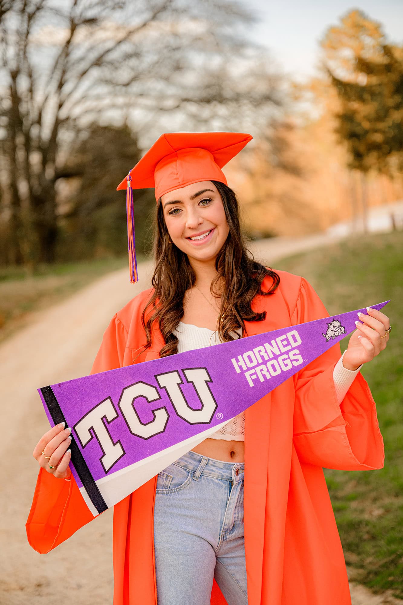 Marvin ridge high school grad holds TSU college gear pennant while wearing her cap and gown