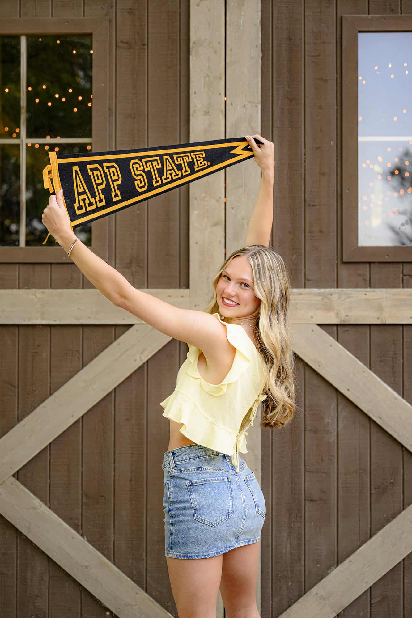 parkwood senior holds app state pennant as her college gear piece for her senior portraits