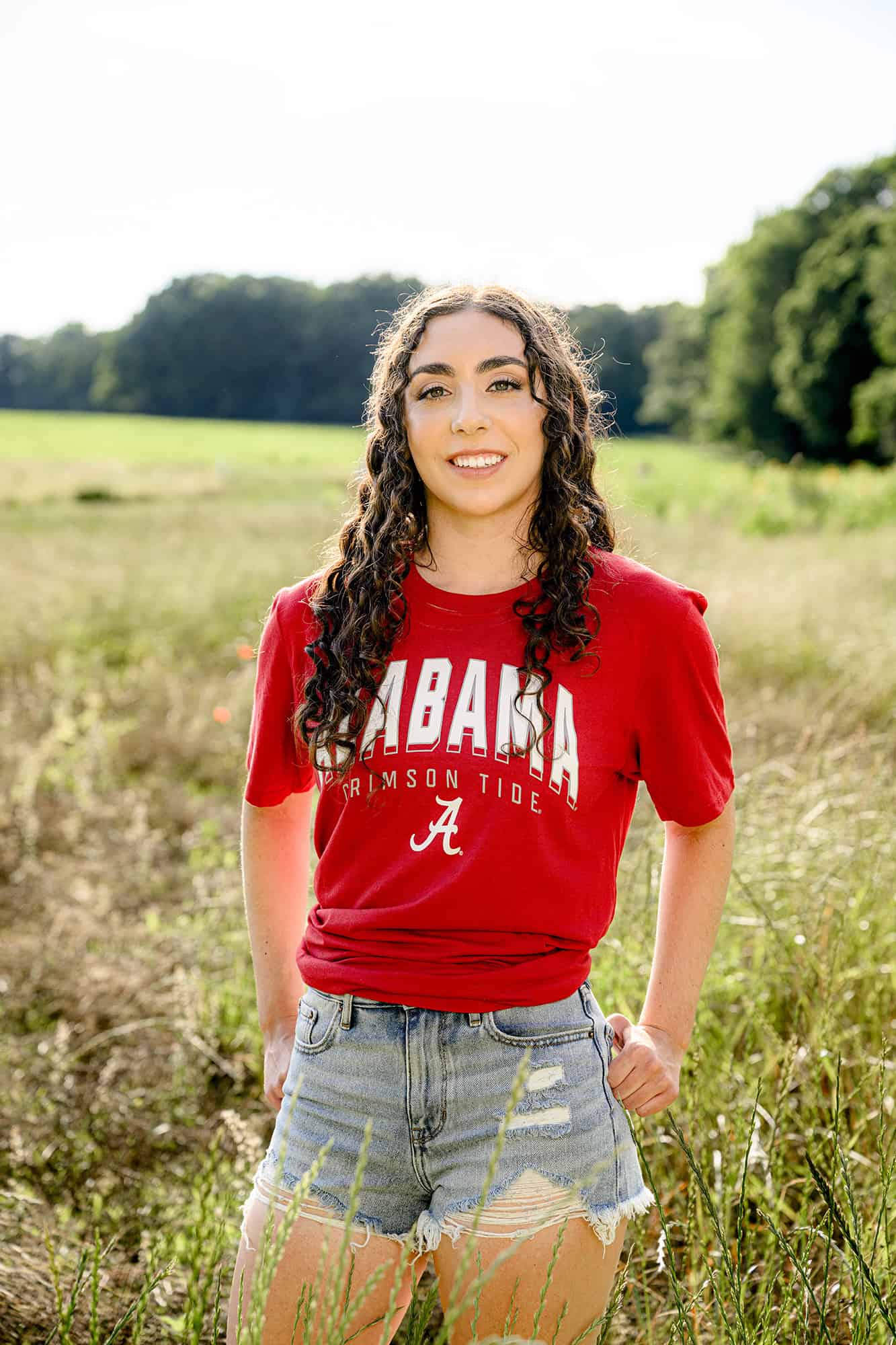 curly hair charlotte senior wearing her alabama college gear t shirt