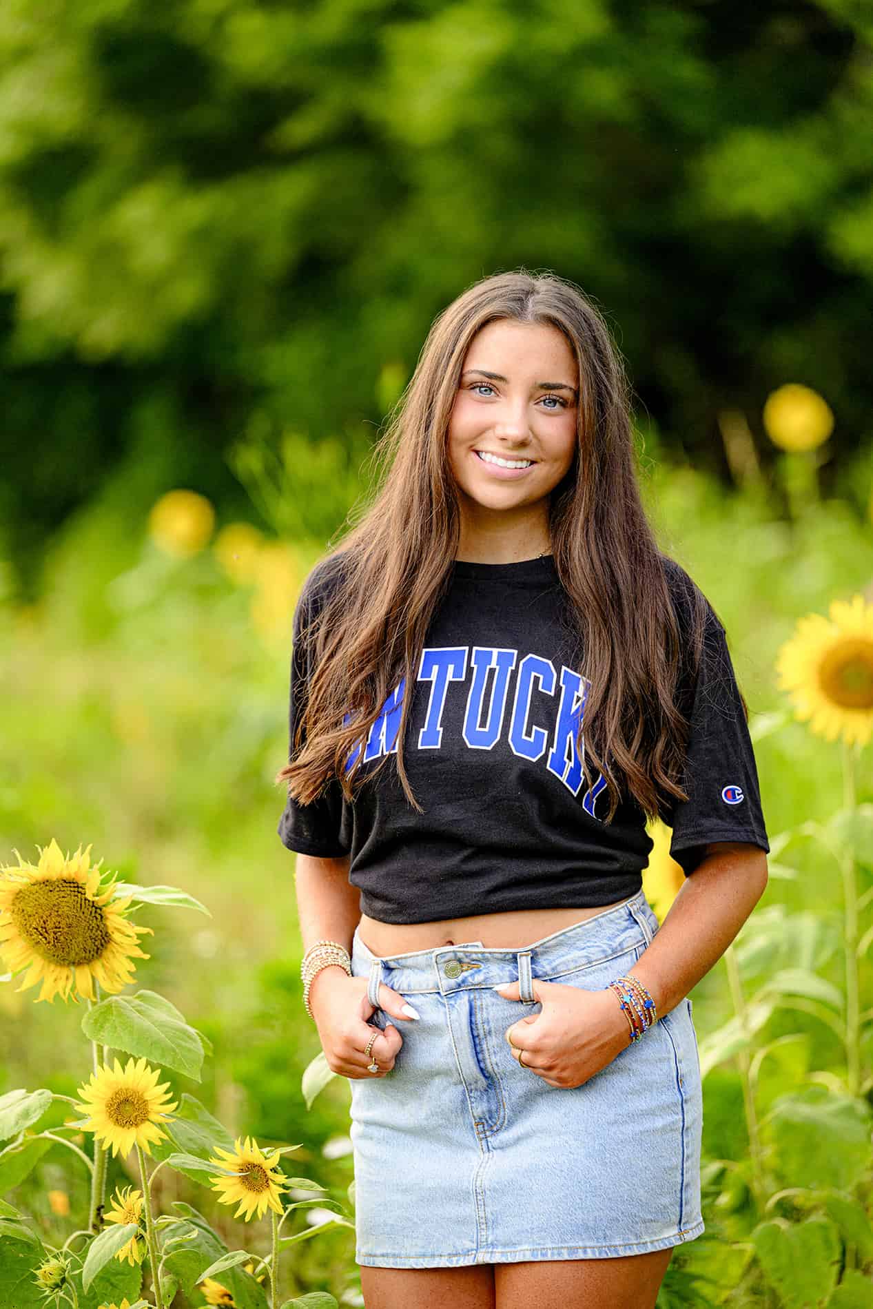 black UK shirt on high school student in sun flower field