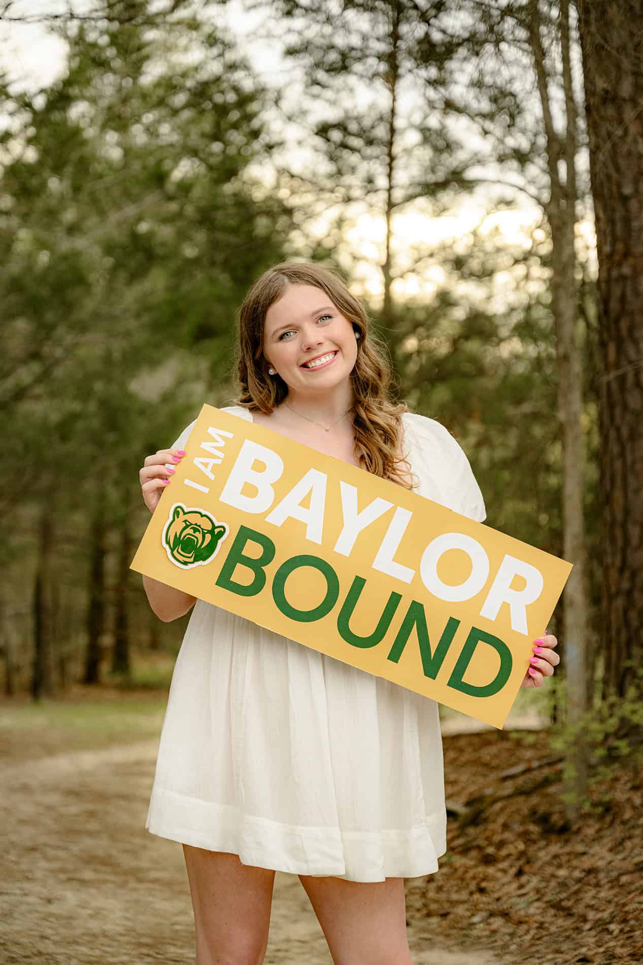 baylor bound sign college gear in the hands of future high school graduate