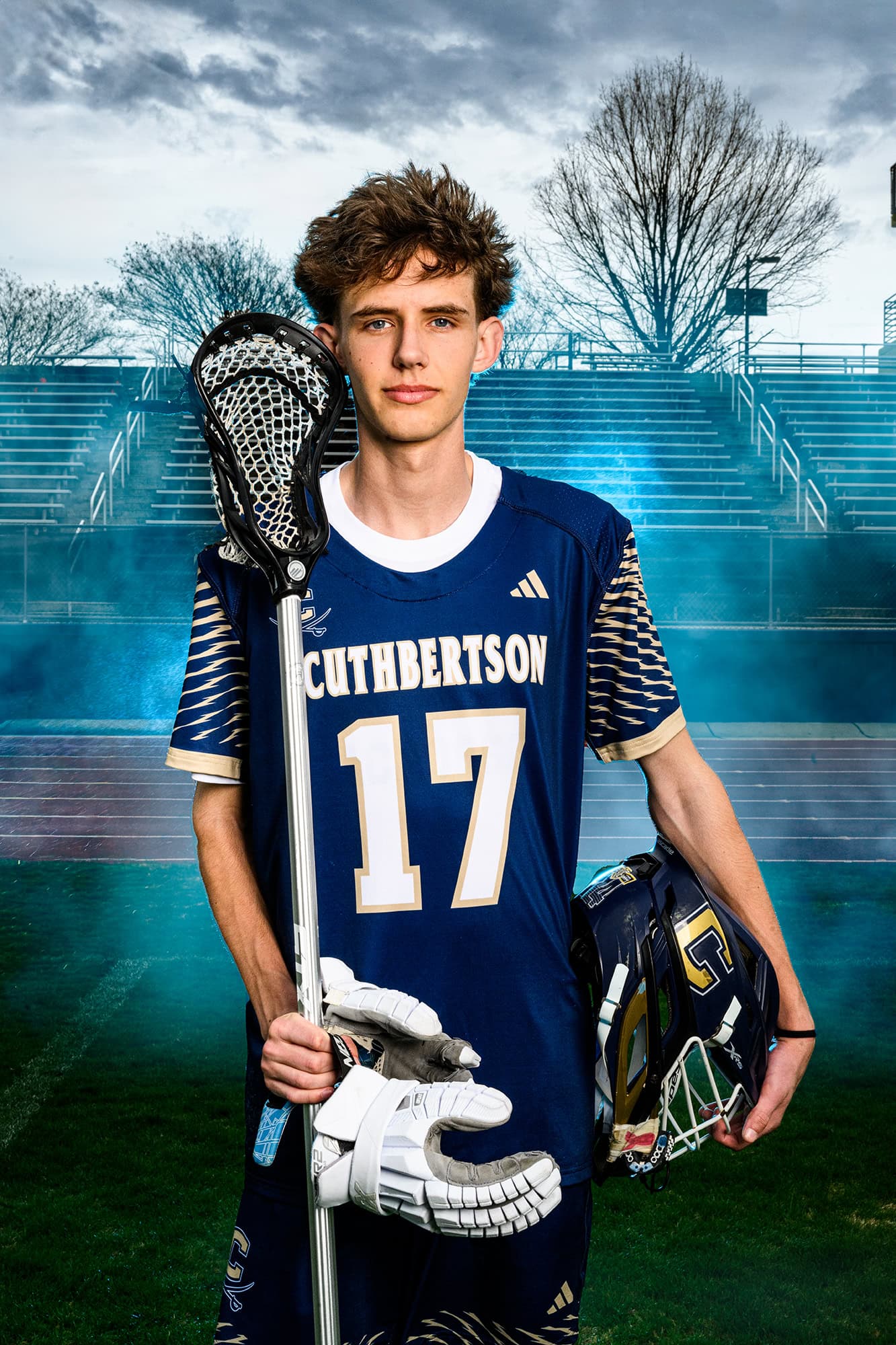 cuthbertson sports athlete holding his gear wearing his school blue uniform