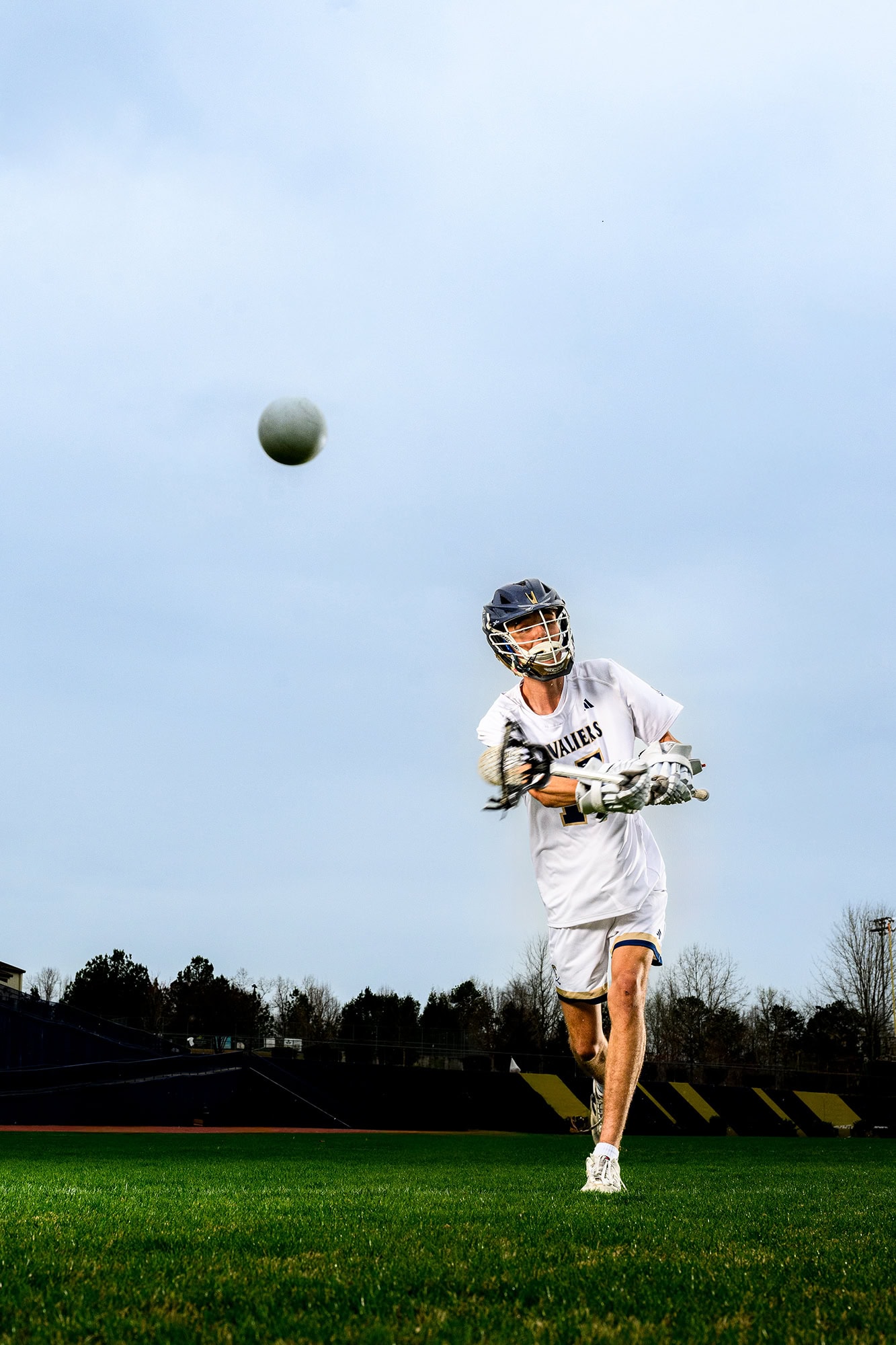 charlotte senior lacrosse player tossing a ball into a net