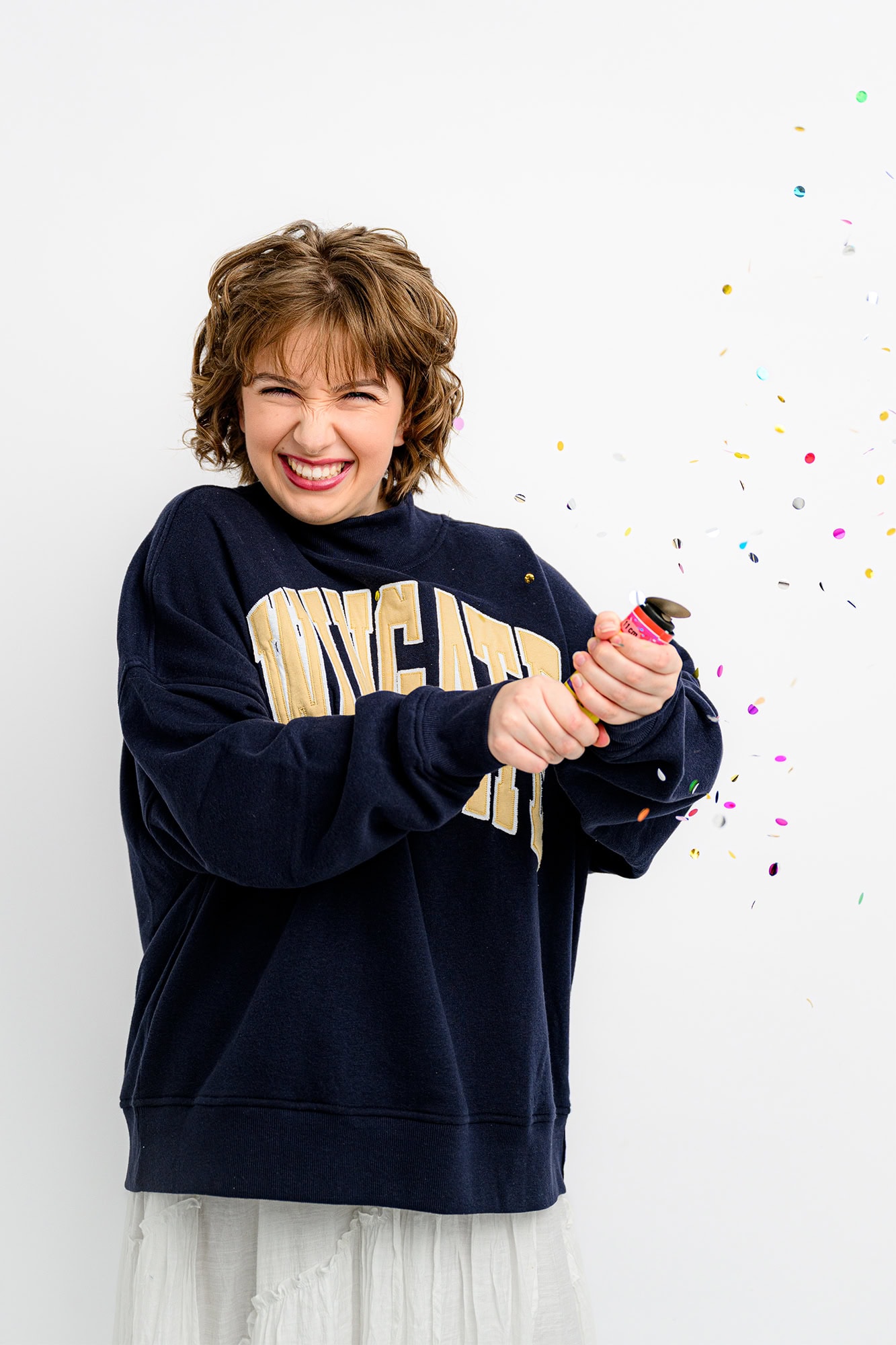 charlotte senior popping a confetti popper celebrating her future college adventures