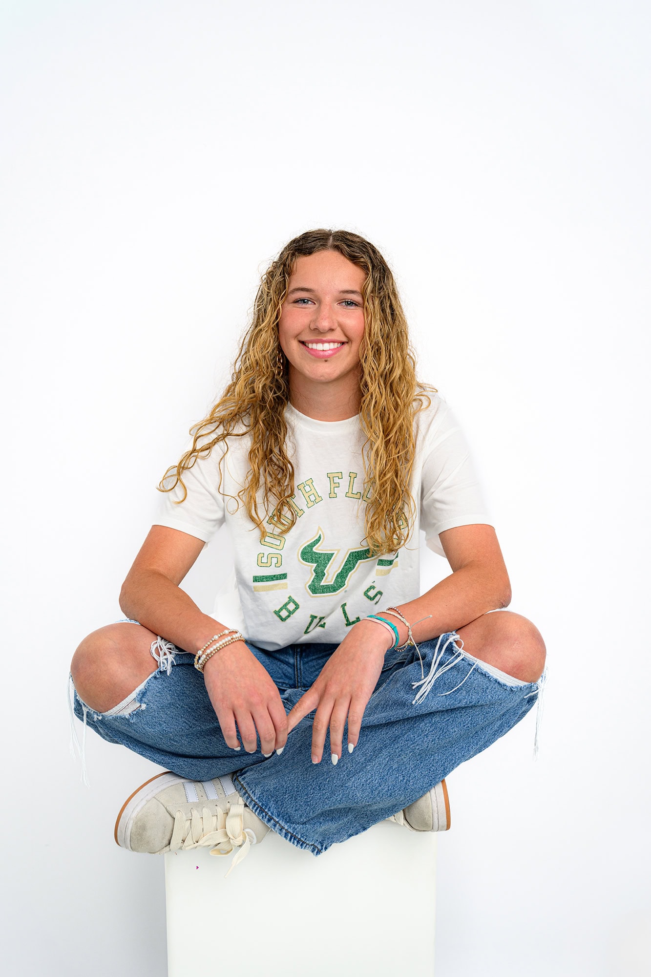 college decision photoshoot with future university south florida sitting in a studio  celebrating her next adventure