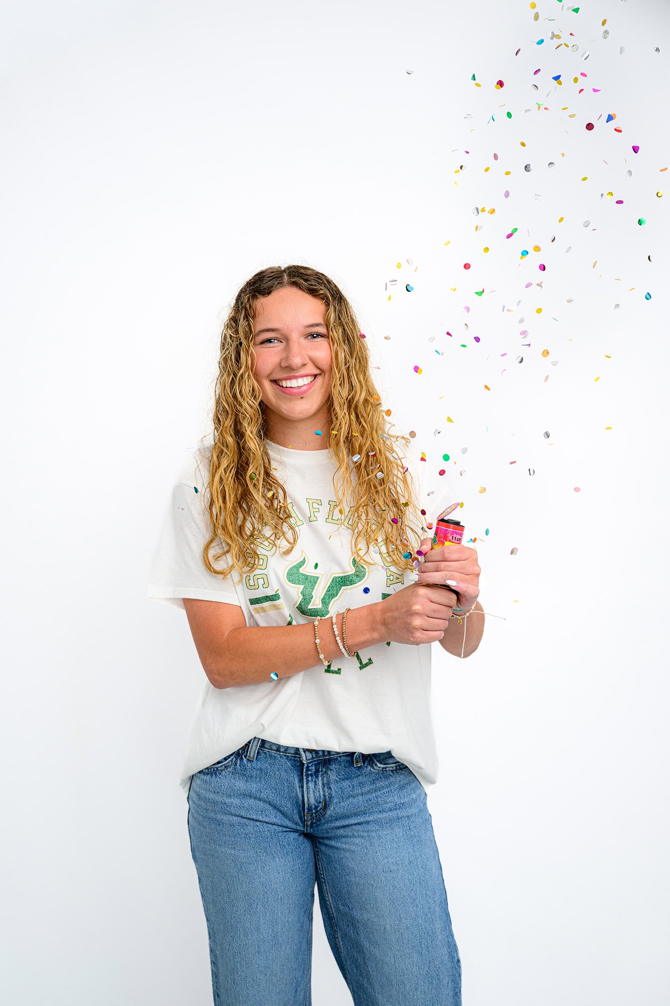Furture USF student celebrates her college decision with a confetti popper