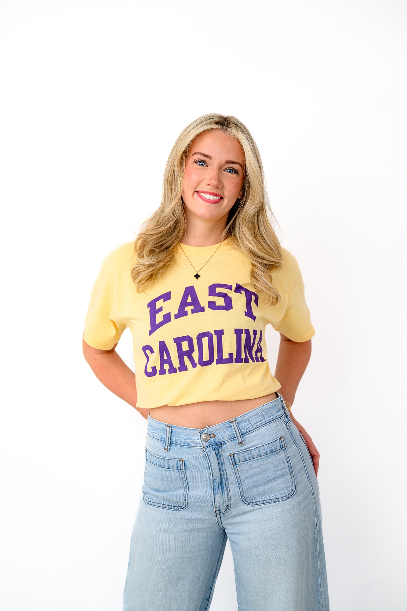 blonde high school graduate wearing her future college t shirt with her hands in her back pocket