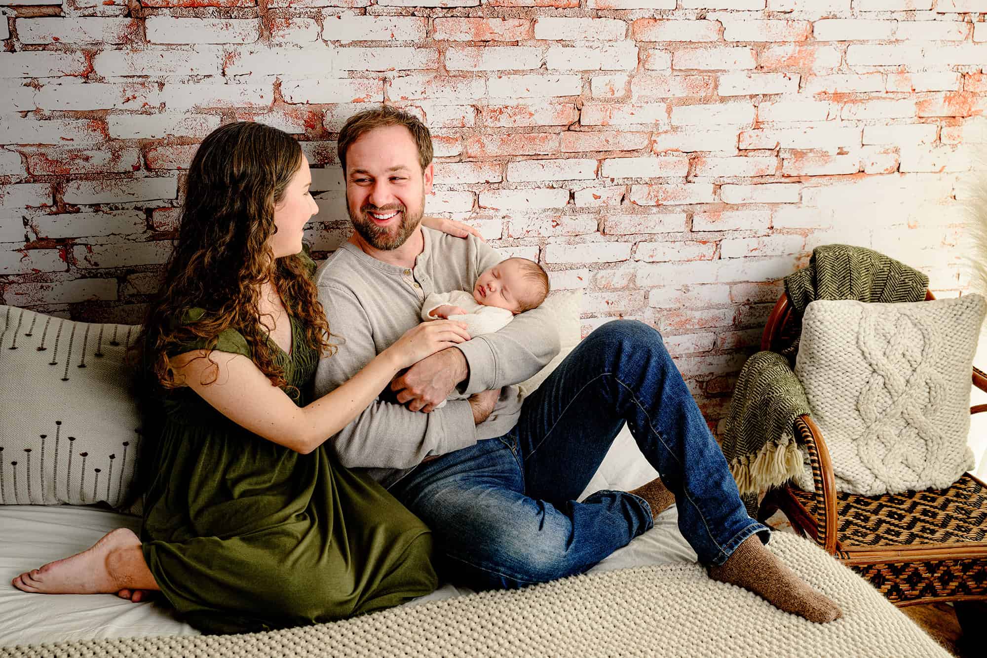 charlotte parents holding their older newborn baby boy