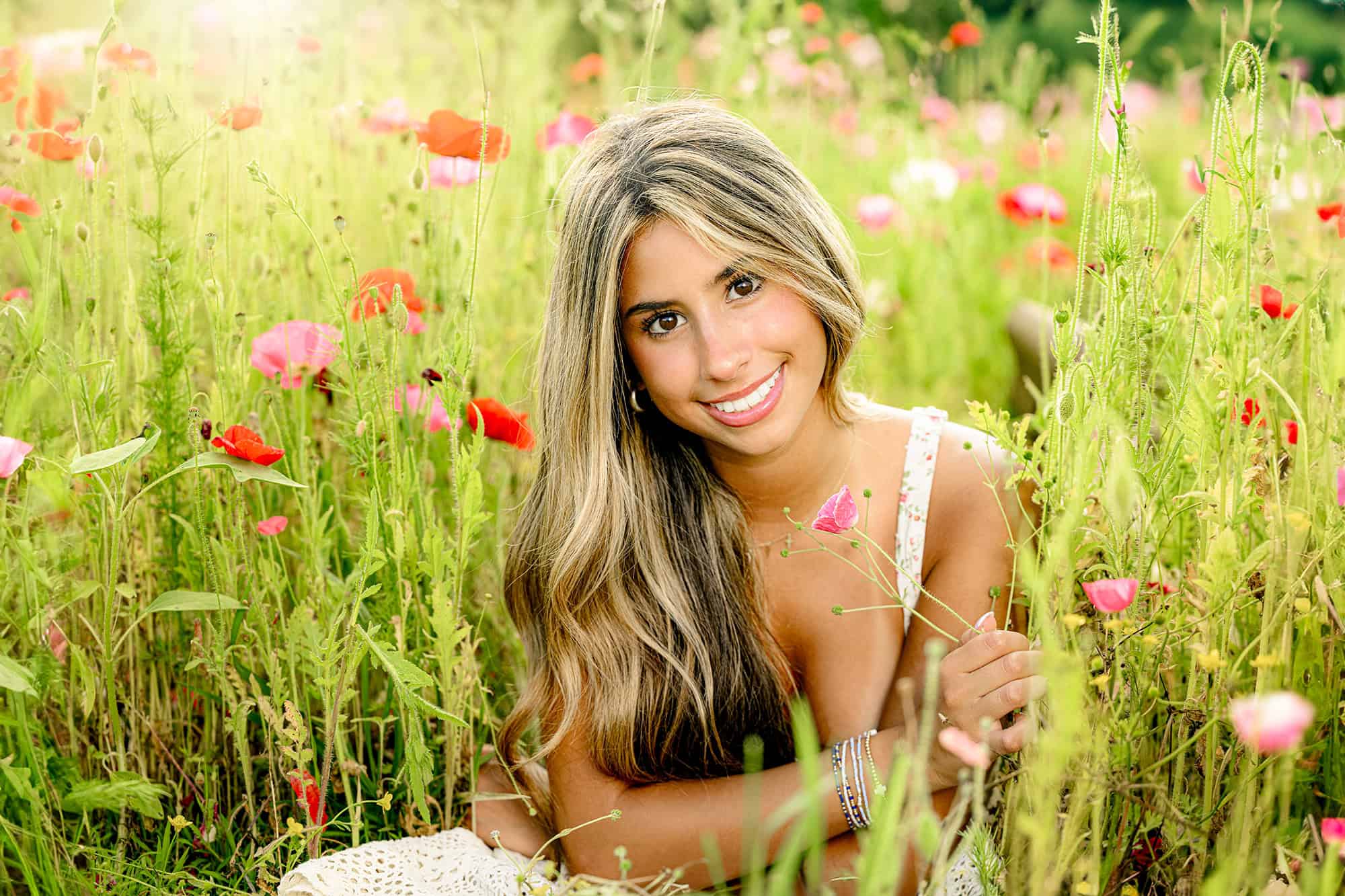 charlotte senior's eyes are the focus in this portrait sitting in a wildflower field 