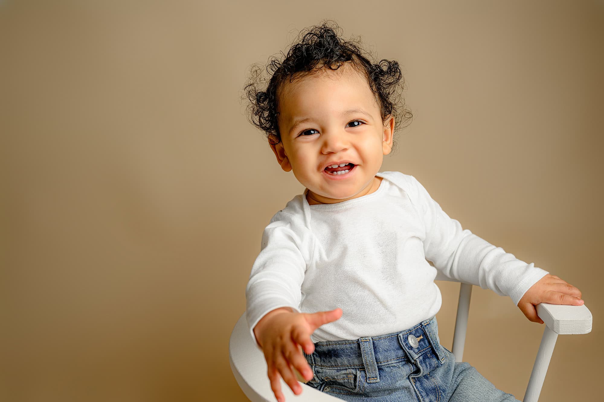 little boy leaning over laughing during his milestone portraits