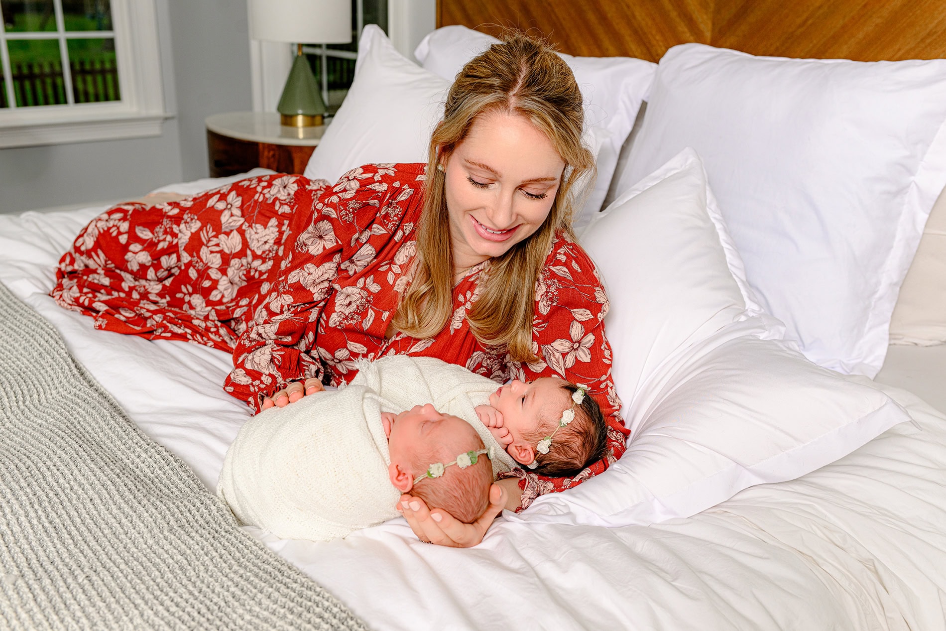 newborn lifestyle twin session with mother holding her twin girls wrapped in white