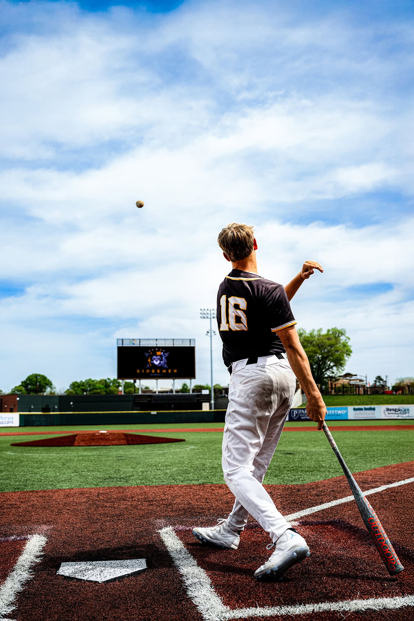 home run shot of kingsmen academy senior athlete at bat hitting a baseball to ourfield