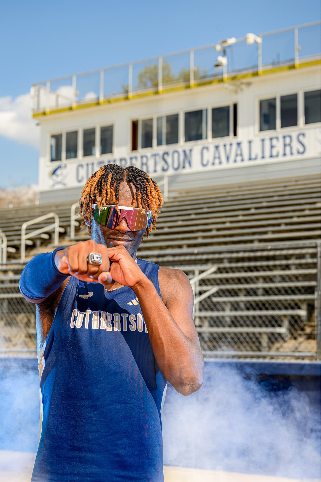 track and field athlete punching to show his state ring in the CHS stadium