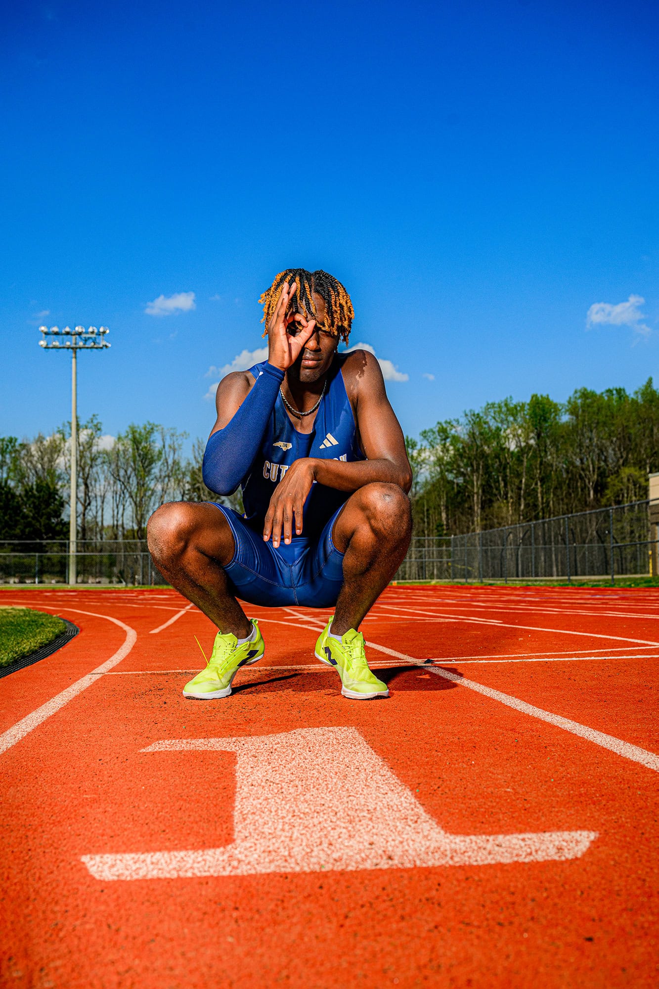track and field athlete in lane one wearing his cuthbertson high school ahtlete