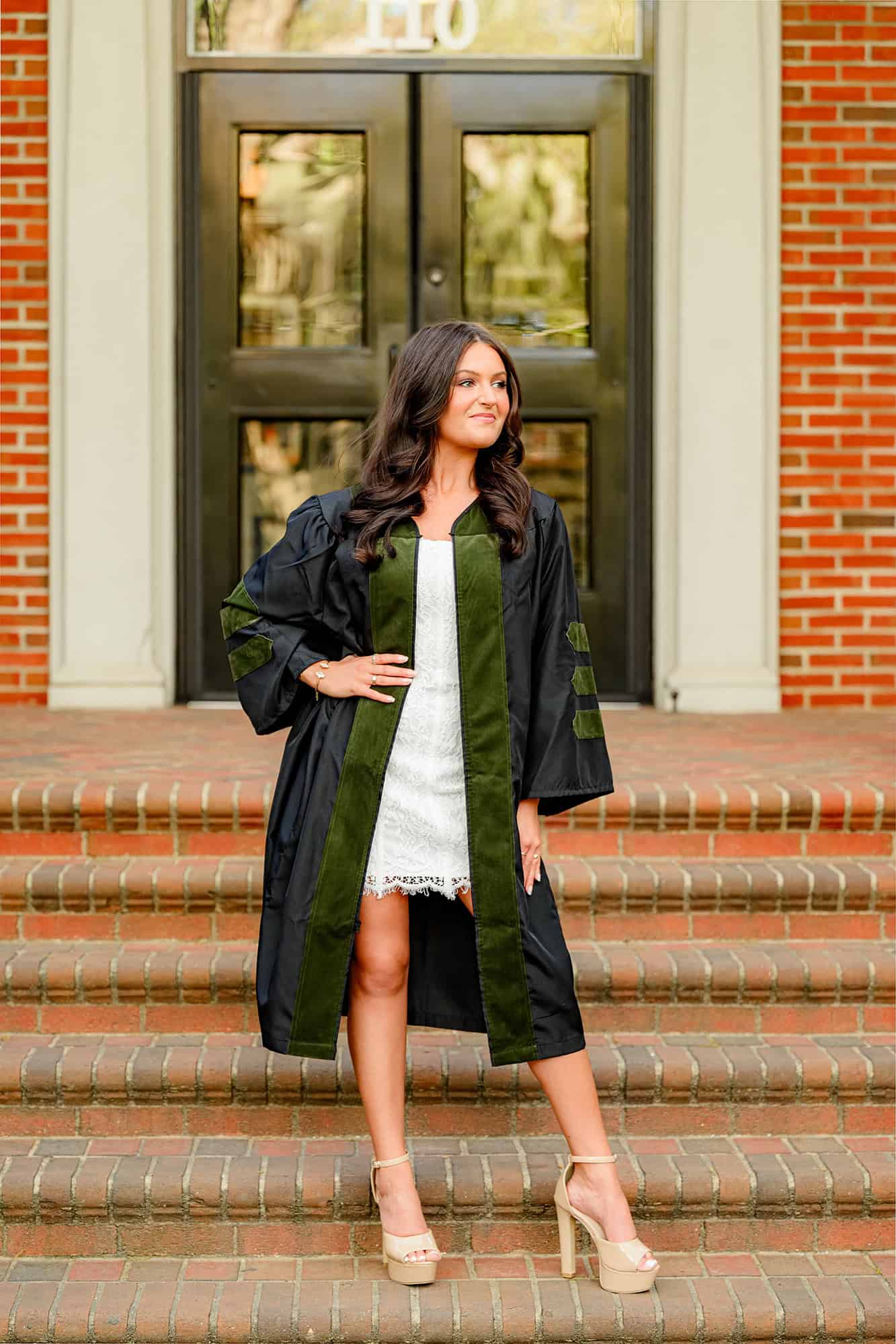 university grad portrait of wingate PhD student wearing her graduation gown standing on steps 
