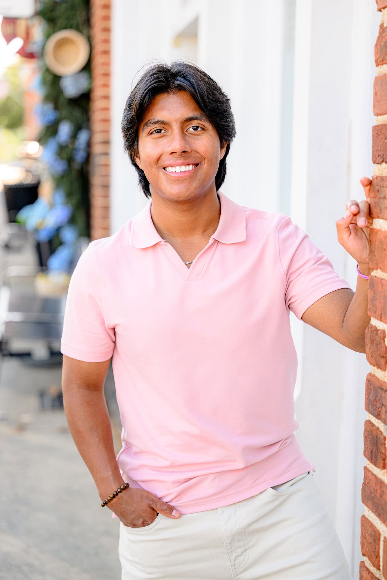 morning light photo of senior boy wearing a pink shirt in downtown waxhaw, nc