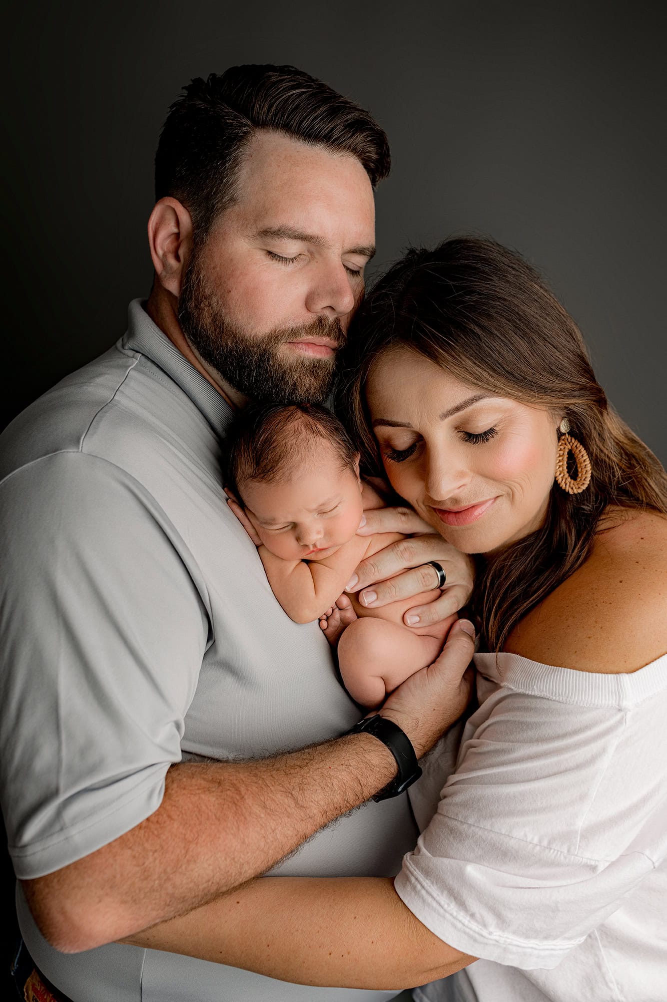 Newborn Charlotte parents holding their son during their newborn photos that were a baby shower gift from their registry