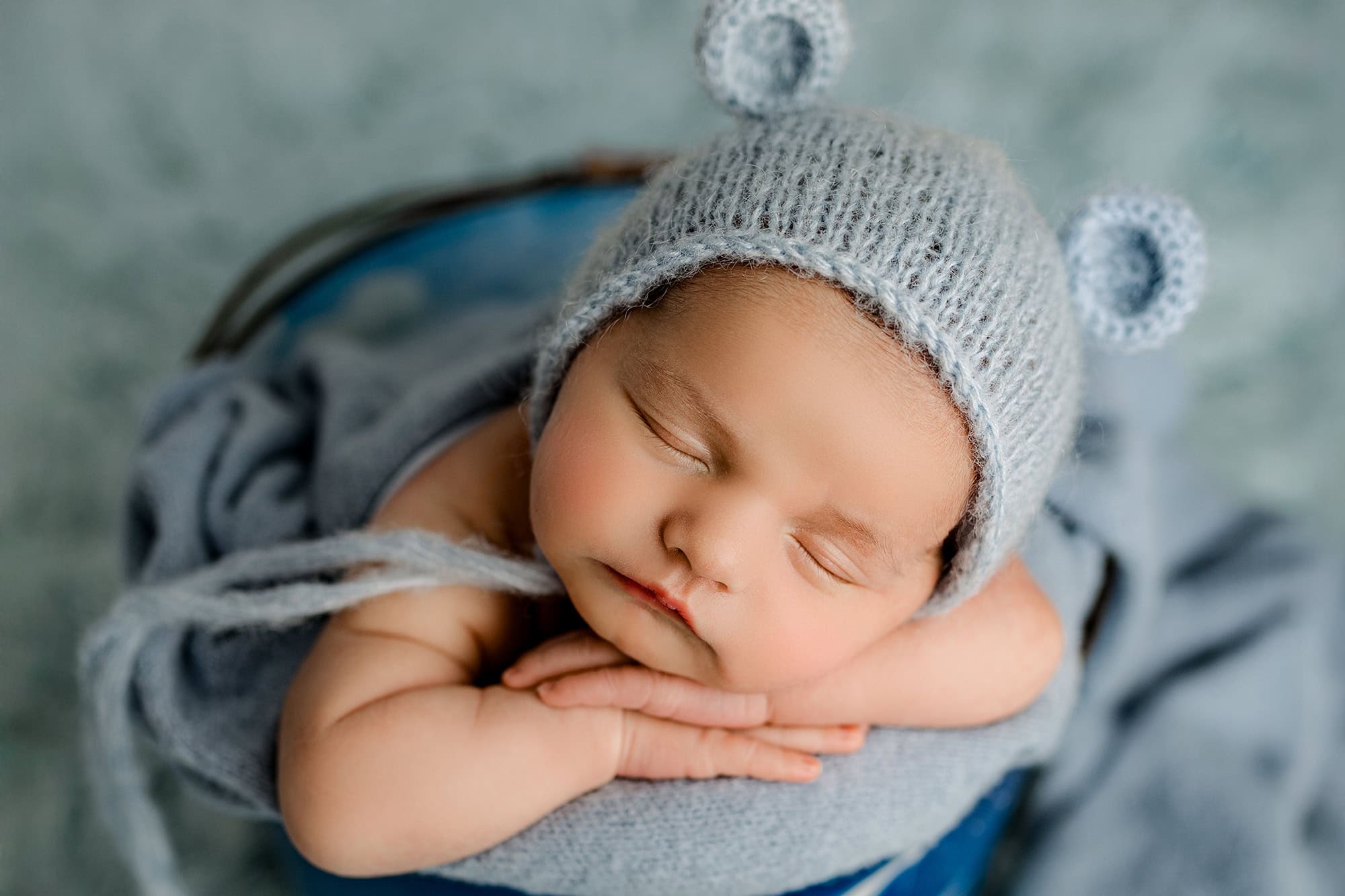 Charlotte newborn baby posed in a bucket for his studio newborn session as part of his parents registry gift