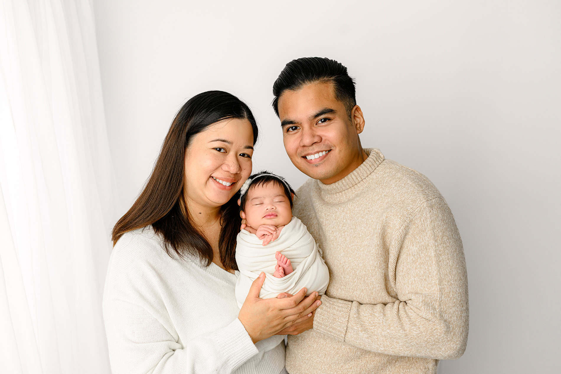 parents holding their newborn baby girl in waxhaw, nc area studio