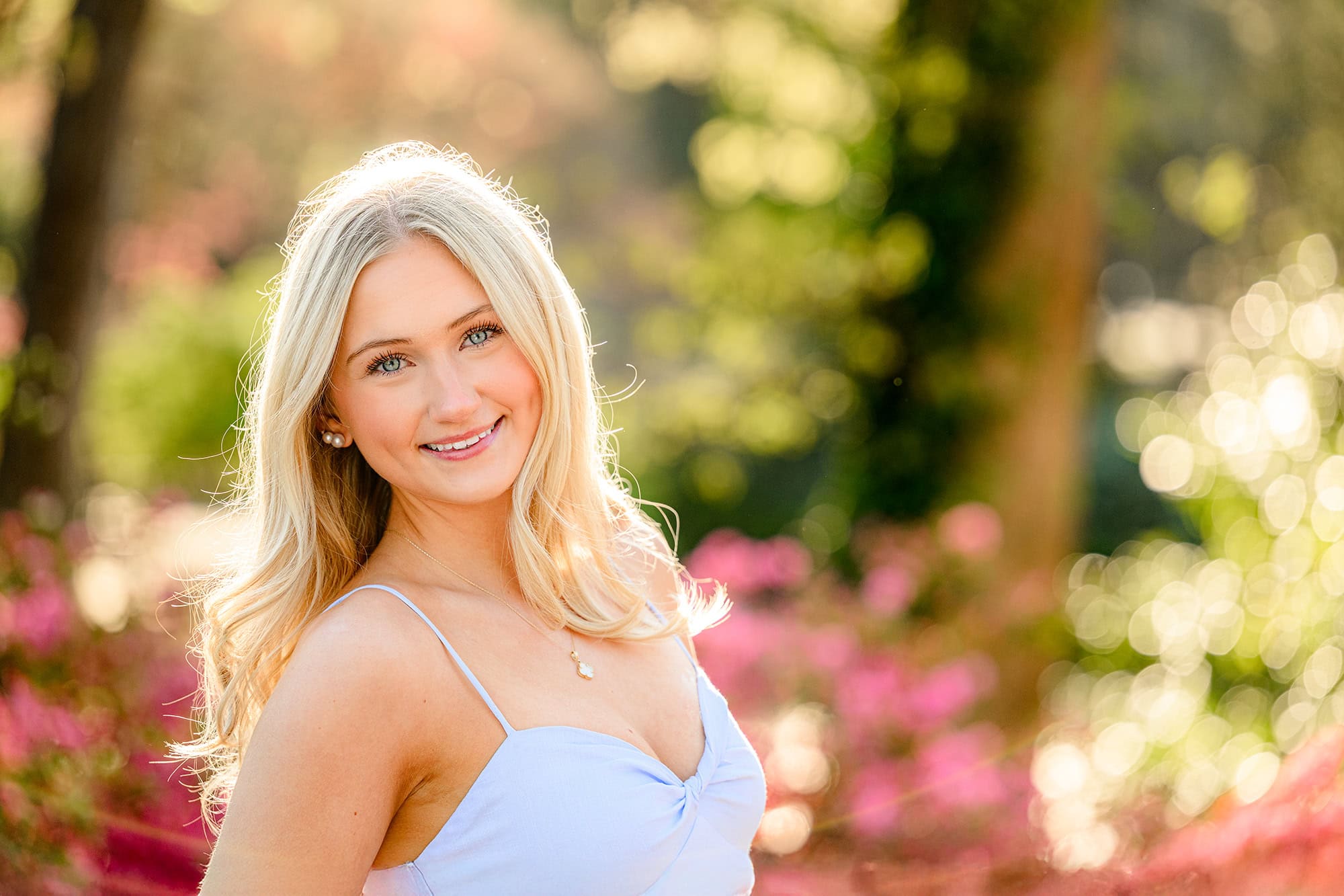 blonde charlotte catholic senior with golden glow on her hair during senior photos